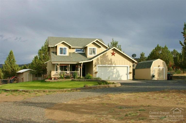 Over 2 acres of country living just minutes from town. Enjoy sunsets from the covered front porch & sunrises on the back! Inviting home w/cozy gas Fireplace, White Washed cabinets, Hickory floors, Granite counters, SS Range Hood & unique spaces. Spacious Master w/Mountain Views, additional Guest Qtrs/Studio/Shop outside. Huge fenced garden w/drip system & Potting Shed, additional Storage Bldg & Hot Tub just off the covered back deck. Plenty of space for RV, all your toys & room to build RV garage/shop.