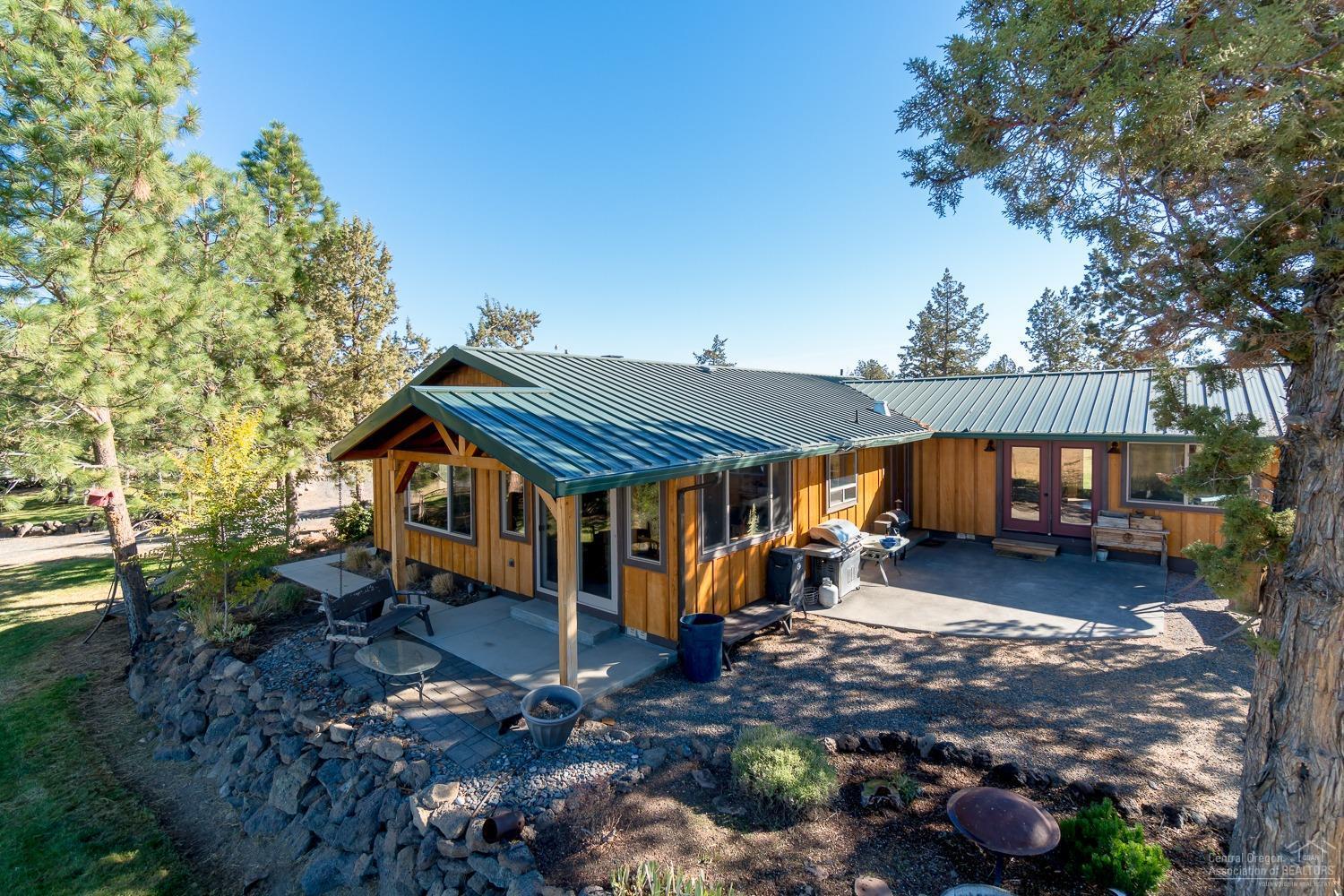 Sweeping Mountain Views from the Cascades to the Ochocos! Secluded country living on nearly 13 acres with a custom 3 bedroom, 2 bath home situated in heart of Powell Butte. 11.8 acres of water rights for crops or pasture. Home has a modern rustic feel w/an open floor plan, vaulted ceilings & luxury amenities. Granite counters, SS appliances & a floor to ceiling rock fireplace in living room. Spacious Master Suite opens to the patio w/french doors, double closet & walk in tile shower. Horse ready property w/ hay barn offering 2 covered stalls, property is fenced/cross fenced. Additional 2 bay shop & 2 bay open carport. This unique property is a great place to call home!