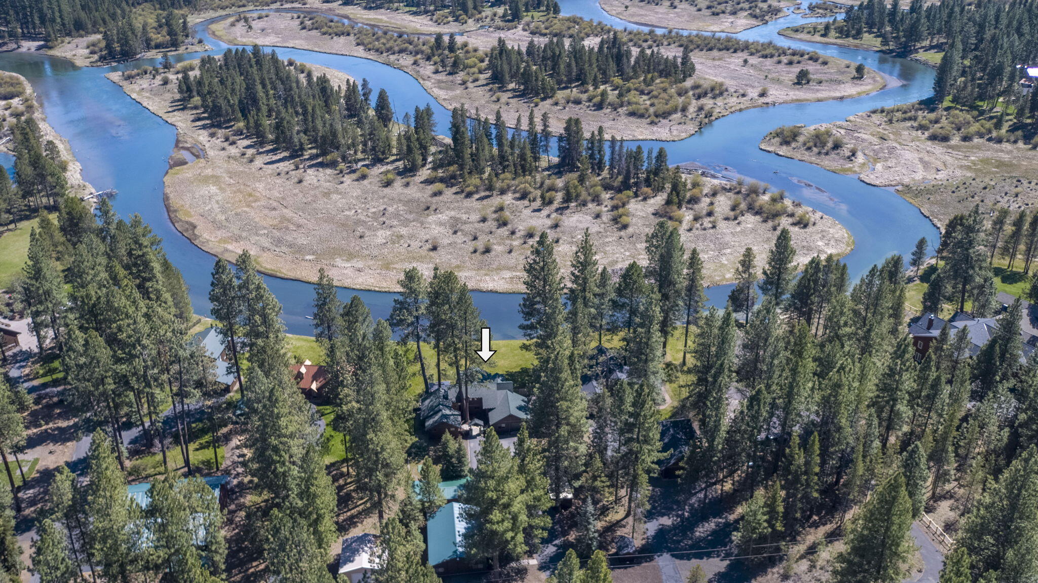 Only a few will call this portion of the Big Deschutes River home. Located in the celebrated River Forest Estates w/ paved roads, tall timber & the river flowing across the landscape. The property has over 100ft of unobstructed river frontage & views with no obstructions. The home boasts quality craftsmanship & was completely rebuilt in 2012-thoughtfully designed so all living spaces enjoy the views. High ceilings, cross beamed, floor to ceiling windows, custom stone fireplaces, spacious private primary bedroom on main floor. Home has 3 bedrooms, office, & large bonus room overlooking the living space. In addition, there is a 1364sqft. heated shop w/ bathroom, 110 and 220 amp. A 42 x 30 RV/Car/Boat with 30amp, septic & water, plus a 630ft 42x15 detached garage w/ power. Fenced yard, dock, hot tub. new well, fresh paint, & new roof. Located in the heart of Central Oregon recreation area, a short drive to Sunriver, Mt Bachelor, the Cascade Lakes, US Forest Lands, & 25 minutes to Bend.