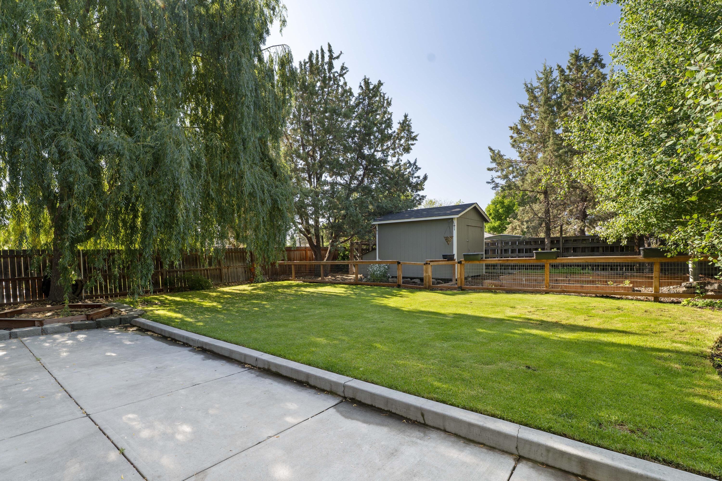 Back on the market at no Fault to home/Sellers!
Located on a tree-lined street in desirable SW Redmond, this well-maintained 3-bedroom home includes a spacious upstairs bonus room that can serve as a 4th bedroom. The main level offers flexible living with two distinct living areas—ideal for a home office, schoolroom, or second family space. The updated kitchen features Bosch appliances and enjoys excellent natural light throughout the day. The fully fenced backyard is a private retreat with mature trees, a gated garden, large storage shed, chicken coop, and paved patio area with new awning. Additional amenities include a lean-to for storage on the east side of the home, designated RV/trailer parking, and a tandem 2-car garage. No two-story homes behind the property ensure enhanced privacy and open sky views. A thoughtful layout inside and well-planned outdoor space make this property a versatile and inviting place to call home.
New Redmond Rec Center- Walking Distance
Qualifies US
