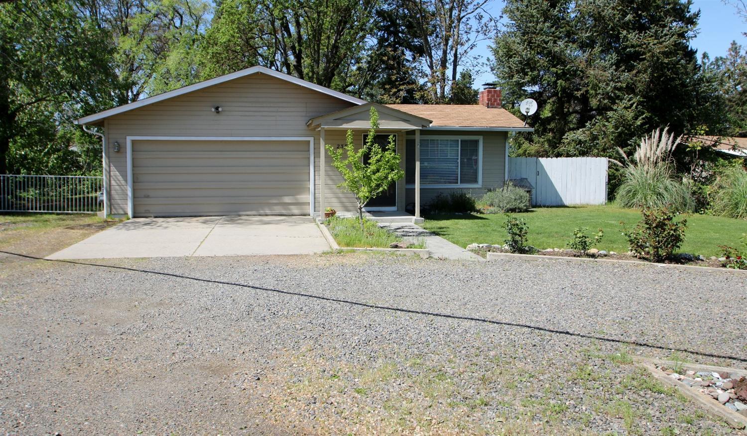 This home is all about classic Central Point charm, location, and versatility of the property. First, the home is very clean, well taken care of, and ready for YOU! The kitchen is adorable with glass cabinets and vintage style, with a peek-a-boo window looking out to the living areas. New water heater and dish washer. The property is pristine with the Rogue River irrigation ditch meeting up with Jackson Creek at one corner of the property. Irrigation rights are currently $239/yr, hand lines, pumps, and sprinklers remain so you can care for this .45 acre lot. A circular driveway gives you plenty of parking and gated RV parking so you can easy store your 'toys'. There is a 20x20 shop in the back with 110 and 220v electricity and a wood burning stove. This home really is a charmer in a great location! OWNER CARRY TERMS AVAILABLE!