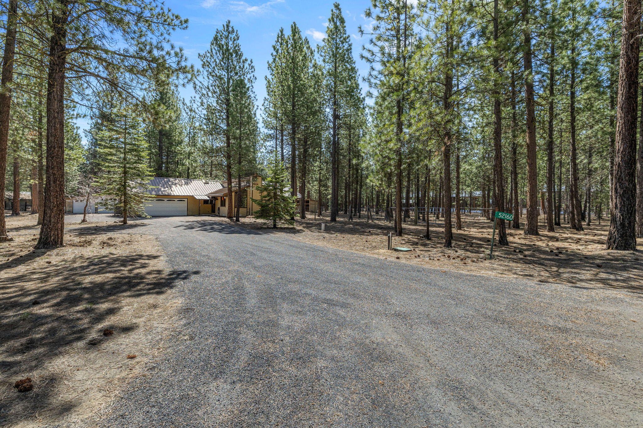 An incredible home is waiting for you in Ponderosa Pines! This property features a spacious main house and a separate guest house with a bedroom, full bath, and enclosed porch.The main home has a kitchen updated with granite counters and high-end appliances. A new great room, with a wood-burning fireplace and two sliding doors, leads out to decks. You'll find newer laminate floors throughout, a charming knotty pine ceiling in the family room, and a newly installed electric panel.Outside, there's an oversized two-car garage and a large two-plus car shop with a workbench. The large yard is ready for your personal touch. An adjacent corner lot is also for sale, giving you the option to buy both properties and own the entire corner.Call today to see this great potential home!