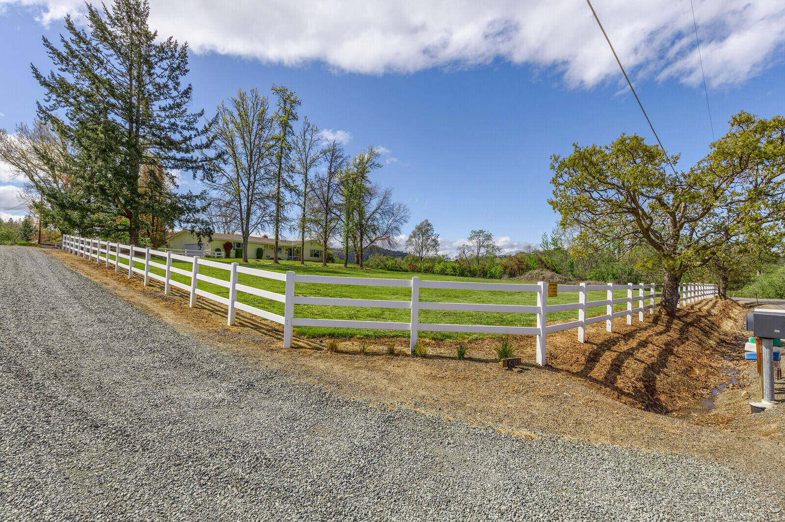 This is the reason why people want to live in Southern Oregon; this peaceful panoramic view property is located off a quiet drive minutes from town on 2.46 fenced irrigated acres, providing a comfortable country feel w/ the conveniences of town. Lots of room for hobbies w/ both an attached 2+ car garage & a small barn. The one story ranch style home features an open floor plan w/ a remodeled kitchen w/ granite counters, gas cooktop, & double ovens, as well as both eat in & formal dining areas. Huge utility/laundry rm off the attached garage w/ a full bath, convenient when coming in from outside. The comfortable family room has a wood stove for those cozy weather days next to a large office/hobby rm. The primary suite includes a walk-in closet & spa bath w/ a soaking tub & walk-in shower. Two additional large bedrooms & a living rm located in this wing of the house.  Lots of room for RV parking & both a covered deck & outdoor patio to enjoy all that this wonderful property has to offer.