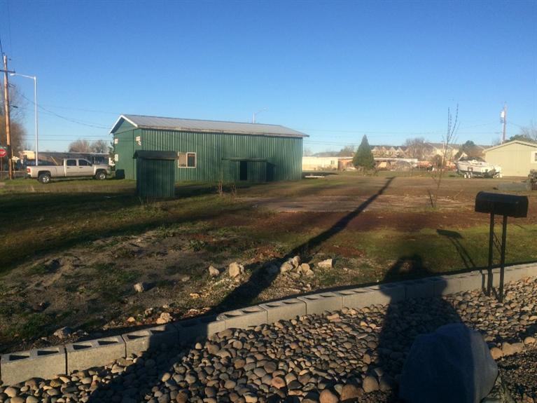 This is a great corner lot located in White City that has both a well at around 80GMPM (per owner) and City Water, Sewer hookup. This lot comes with a 2100 sq. ft. shop that has a Bathroom, Office, and 3 phase power with approx. 600sq ft. of upper level storage space. Shop is set up for almost anything you want to do with it. Move in your Mobile Home or start pouring your foundation for a quick instant setting for your new home and unbelievable shop. Investor opportunity here as well. Buyer Due Diligence. Brown shed/shop will most likely be torn down for new construction or mobile.