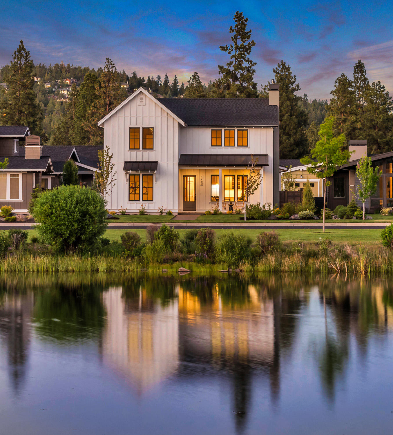 Indulge your farmhouse dreams in this stunning modern interpretation by award-winning Structure Development NW, with upstairs peek-a-boo views of Central Oregon's beloved Cascades Range. Just a stone's throw (literally!) from Discovery Park lake in sought-after NorthWest Crossing, this custom home spares no detail with its immaculate and evocative craftsmanship: Roughhewn beams, oiled plank floors on the main floor, along with an eye-popping, professional-grade gourmet kitchen w/ custom cabinetry, solid surface counters and pastoral farmhouse sink. Appealing main level master suite includes decadent walk-in shower and closet, radiant heat floors & soaking tub, plus a main-level guest suite! Upstairs, two bedrooms & a bonus room to catch those views from; as your office, home gym or reading library for cozy winter nights. 2-car garage, laundry and mud room manage your day-to-day life in the high desert. Bring your porch swing for those sunsets!