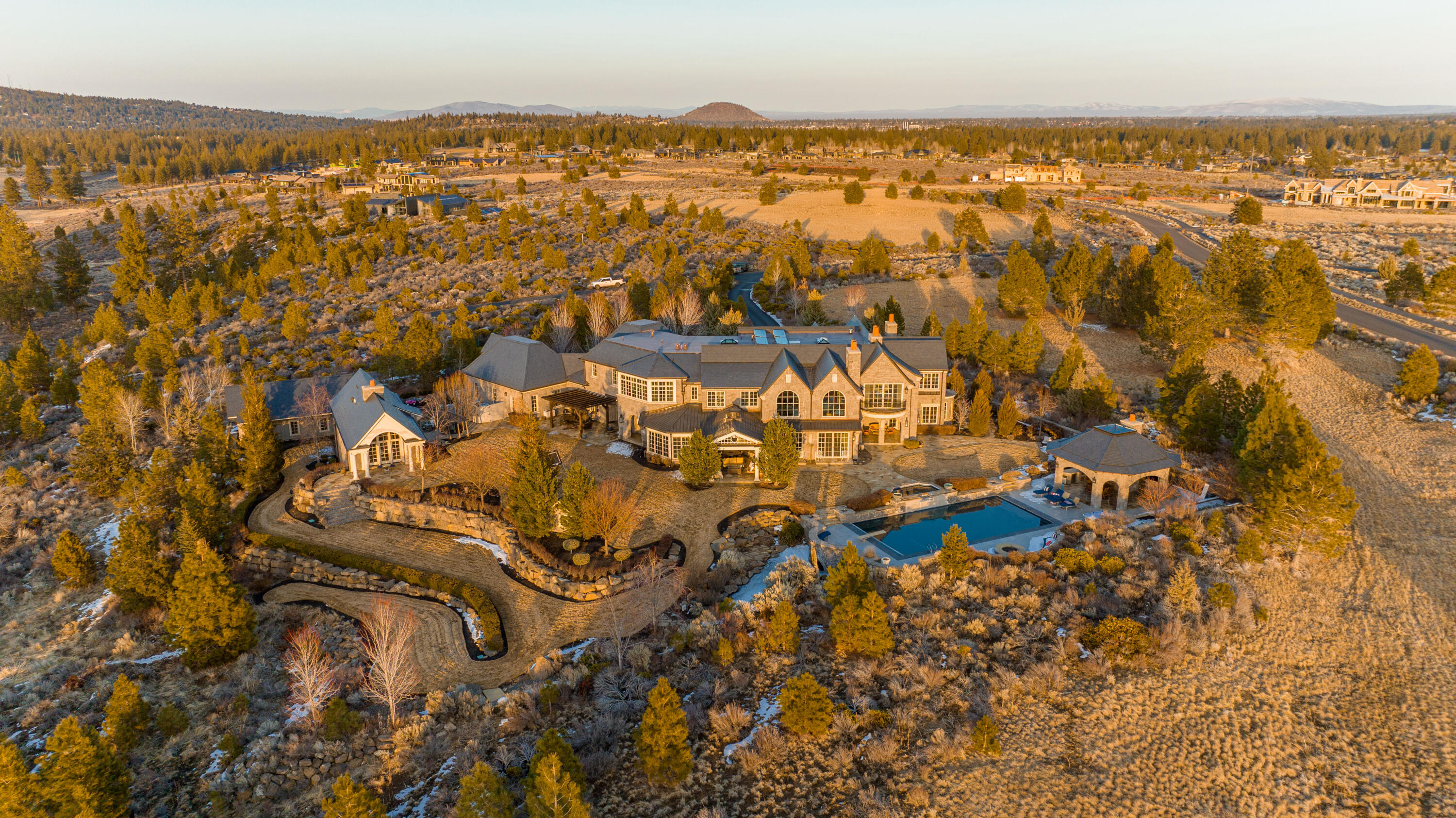 This elegant and luxurious private estate in The Highlands of Bend, Oregon is an architectural treat designed by renowned Harrison Design. Thoughtfully curated with no expense spared, the level of customization throughout the home and property is unlike any other. Details range from the hand selected stone from Jerusalem to the hand-blown Murano chandeliers; the level of detail continues in every room. Situated on a spectacular 10 acres with explosive 360 degree views that include the Cascade Mountain range. Features include a private guest home, attached 4 car garage, detached 4 car garage and RV garage with hookups and dump. Outside soak in the direct afternoon sun from the pool and entertain from one of the two outdoor kitchen areas, one off the house and the other in the covered cabana that is also home to a changing room and bathroom inclusive of a shower. Located just minutes to downtown, schools, golf, and all the outdoor recreation Bend has to offer. See it to believe it!