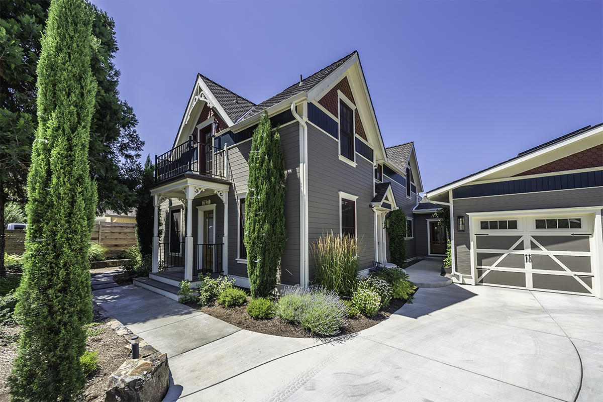 Stunningly renovated craftsman home with high-end modern finishes, located within a flat mile of Ashland's downtown. Seamless addition by Advantage Homes in 2017 added over 1,300 square feet of living area to the main level. Quality amenities include Brazilian Cherry flooring, plaster interior walls, designer lighting, solid-core doors, custom cabinetry and built-ins, composite decks, and view balconies. Kitchen equipped with granite counters, island, eating bar, pantry, Wolf range with dual ovens, stainless appliances, and farmhouse cast iron sink. Main level features a family room, office, living room with gas fireplace, two bedrooms, a jack-and-jill bath, and two half-baths. Upstairs master with fireplace, vaulted ceilings, private terrace, expansive wardrobes, en-suite bath with two separate vanities, stone tile, cast iron soaking tub, and shower with skylight. Landscaped grounds, mature trees, rock fountain, terraced gardens, lawn, and poured concrete patio with gas firepit.