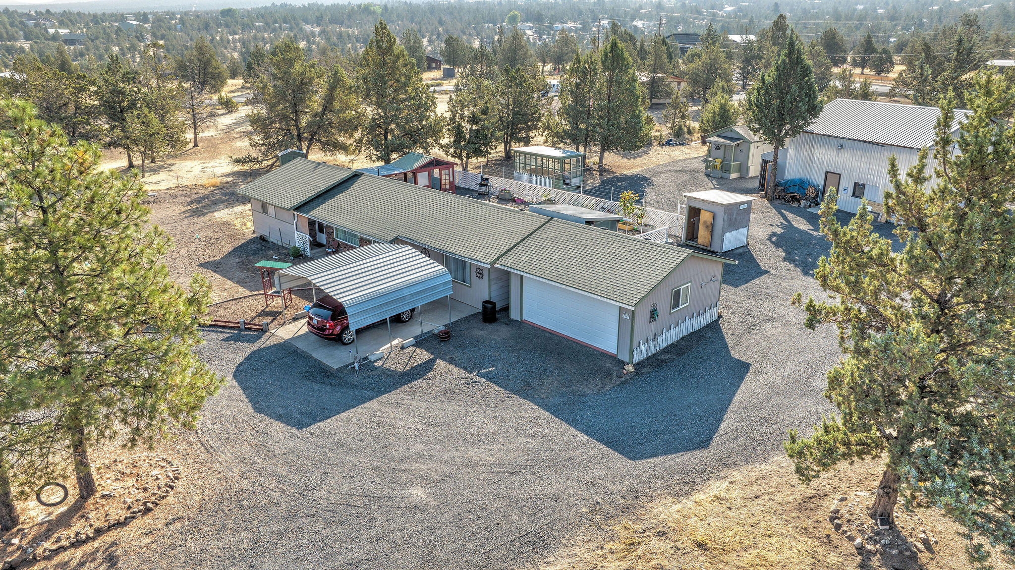 Here's a great opportunity to have almost two acres close to town. Property is fully fenced with automatic gated entry. The home, built in 1972 features extensive upgrading throughout. Updated kitchen and flooring. New mini-split this year. New septic drainfield this year. Newer roof and paint. Dry tiny home, with diesel heating unit.  Large shop with separate work room or office. Covered storage area, greenhouse, gazebo, and covered sitting area. Property is well graveled offering plenty of parking and turn-a-rounds with circle drives. Call your favorite realtor today to schedule a showing.
