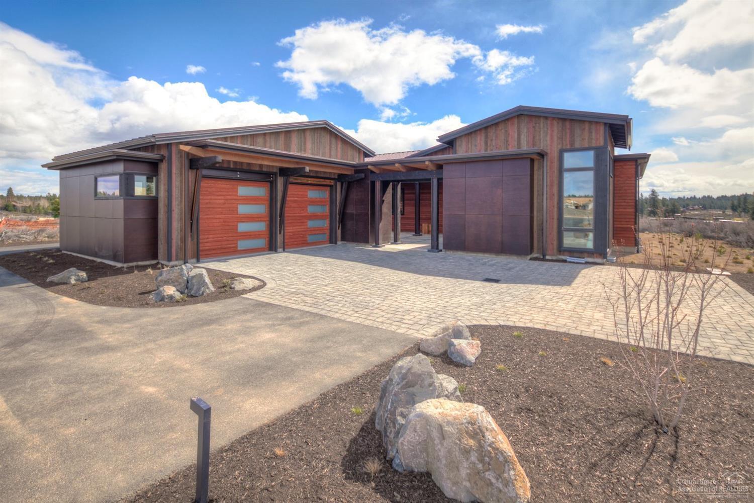 Perched on the ridge facing Tetherow Golf Course, this spacious modern single level home features 3 bedrooms, 3.5 baths, study, & 3 car garage. Move in ready and loaded with goodies including steel accent beams, imported siding from Spain, epoxy garage floors and extensive garage cabinetry, deluxe master closet package, all appliances including refrigerator & washer/dryer, office built ins and more! This is an incredible opportunity in Bend's premier neighborhood, Tetherow!