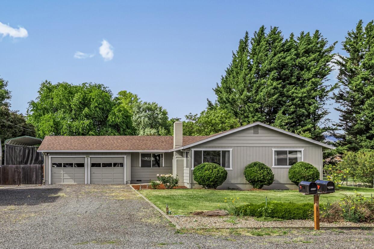 Your own corner of paradise awaits! On the market for the first time since it was built, this lovingly maintained home sits on a generous half-acre in a lush, peaceful corner of the Rogue Valley. There's space for everyone—whether you dream of RV parking, boat storage, a large garden, a play area for kids, or a relaxing outdoor oasis. The fully irrigated lot makes landscape care easy, and the fenced backyard is perfect for your needs. Inside offers comfort with newer laminate flooring, fresh interior/exterior paint, and newer bedroom carpet. The recently replaced roof adds peace of mind. You'll also find large covered RV parking with a 50-amp service panel—perfect for travel lovers or guests. All appliances are included: kitchen fridge, extra fridge, freezer, and washer/dryer on custom stands. Rarely does a move-in-ready home like this come along—don't miss it!