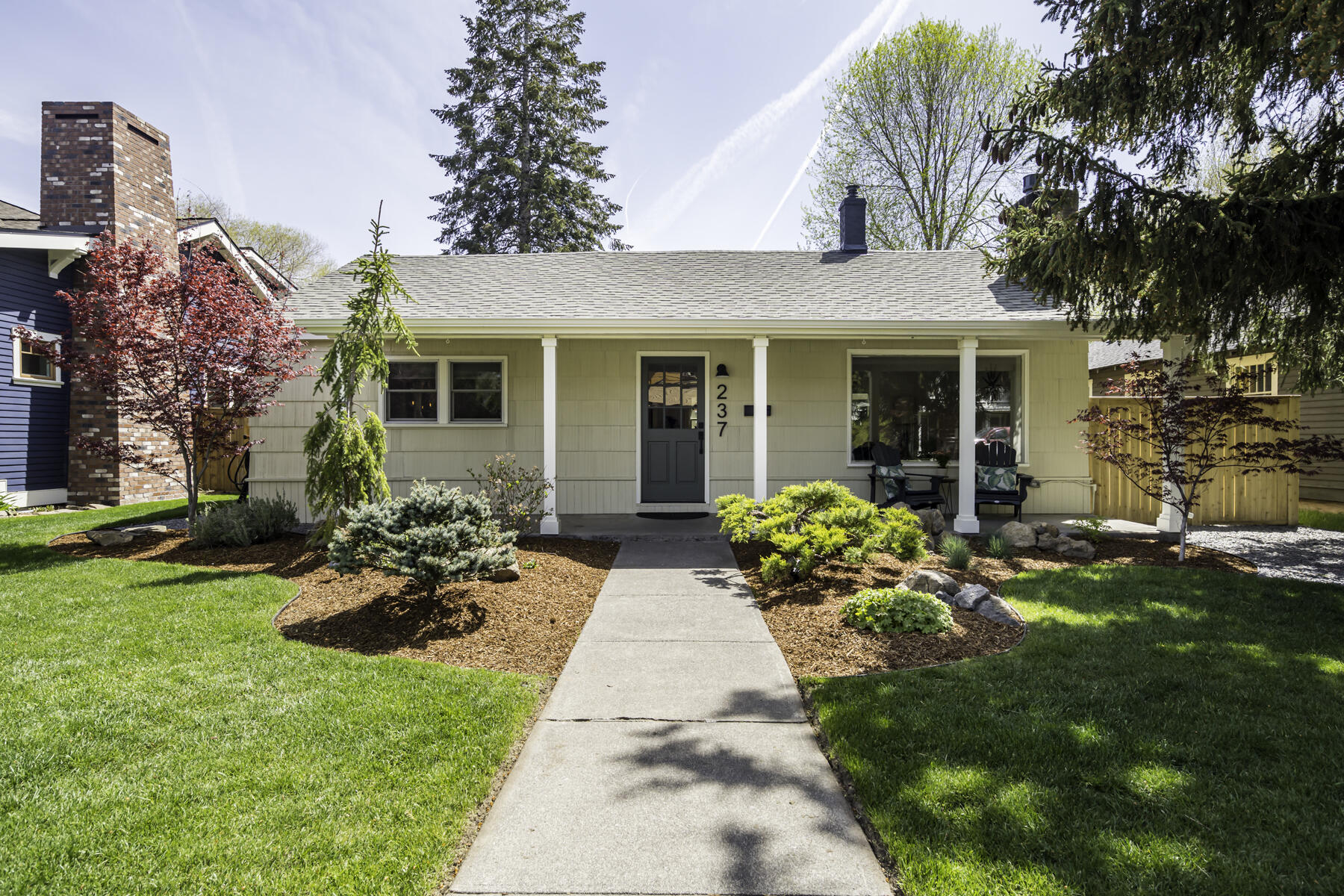 Mid-century modern meets historical charm in a perfect Bend location! Nestled between Downtown & the Box Factory w/easy access to 97, this meticulously cared for home boasts original hardwood floors & custom touches throughout. The kitchen has been recently updated to include brand-new cabinetry, butcher block countertops & tile backsplash. The dining room flows into the living room which has a gas fireplace w/white tile & custom teak shelving. The primary bedroom features a luxurious custom tile shower & walk-in cedar closet. The other two bedrooms are set in the rear of the home next to the second newly-updated bathroom. The fully fenced in backyard has patio space & is nicely landscaped, perfect for entertaining. The 520SF garage (ADU project?) includes newly installed garage doors. This home also has smart home features, basement space not included in the SF & a graveled parking area w/space for RV/boat etc. This home has location, design and opportunity rolled into one!