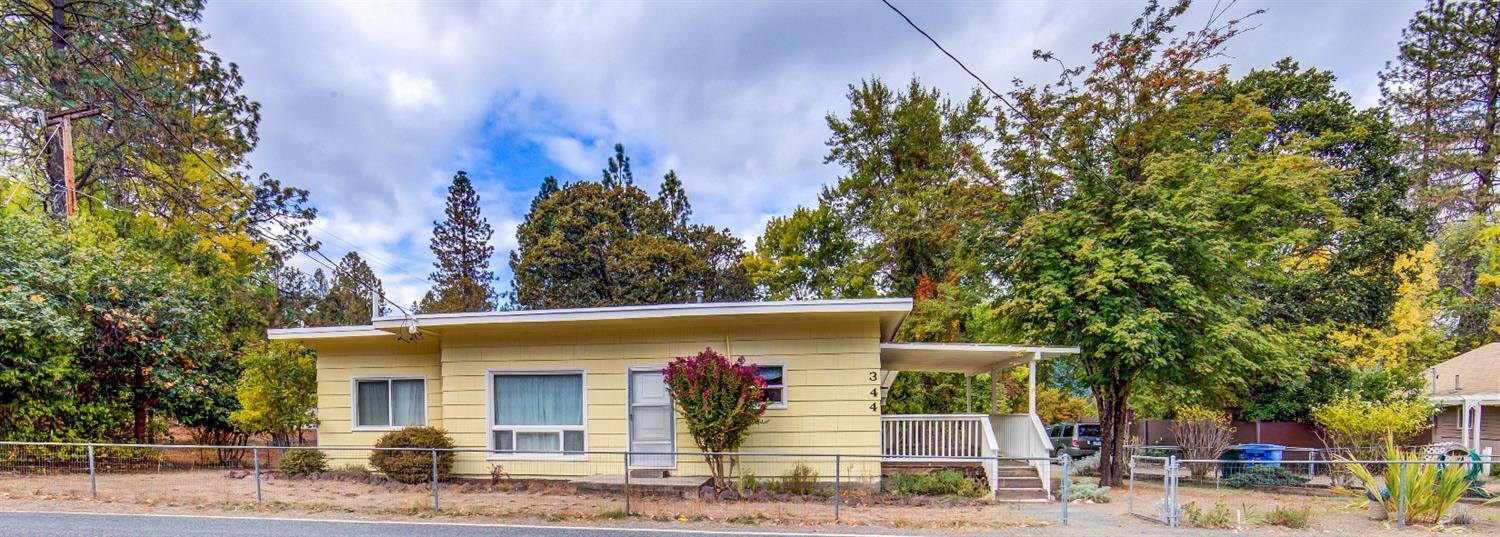 What a great find! Located in a friendly rural neighborhood, yet close to town and city services, this home is a diamond in the rough! Lovingly maintained for the matriarch of the family for many years, it includes hardwood under the most of the carpet, vinyl windows through out, newer roofing, and garden areas around the home. The attached carport is behind the home so sheltered from street views. Attached to the carport are two shed areas that could be storage and shops. The well has a new tank and new plumbing in the to home. Sure, it could use some updating throughout, but seems to be a solid and great starter home! Bring your creativity and turn this vintage cottage into your very own home!