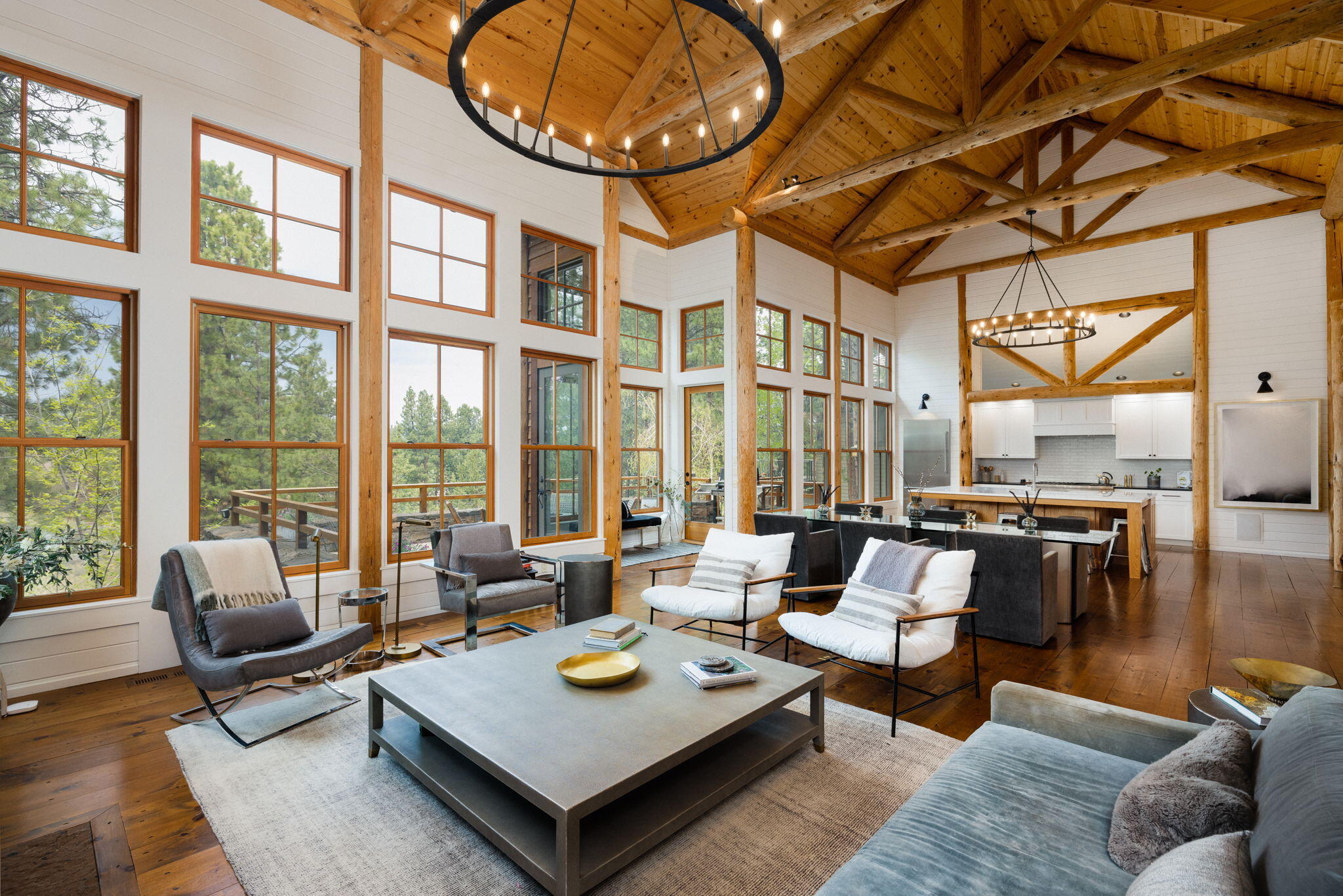 An artful blend of Northwest Lodge architecture and Mountain Modern interior design. Nestled above Broken Top's 15th fairway canyon, on a private cul-de-sac. This unique home's exterior has extensive use of native stone & rustic timbers. A welcoming entryway leads to a grand gathering space anchored by a floor-to-ceiling stone fireplace & vaulted ceiling w/exposed posts & beams. A wall of windows brings in natural light & surrounding scenery. The gourmet kitchen is a chef's dream w/double ovens, a huge quartzite island that seats 6, and a butler's pantry w/additional refrigerator, sink & dishwasher. The main level offers a primary en suite bedroom w/a private balcony and office/den w/fireplace. Lower level has 2 additional en suite bedrooms, fully equipped theater room & large sauna. Walk out to the expansive patio & cozy up around the fire pit or soak in the hot tub as you enjoy the great outdoors. An intriguing upstairs loft bedroom plus a cool hideaway room provide extra flex usage