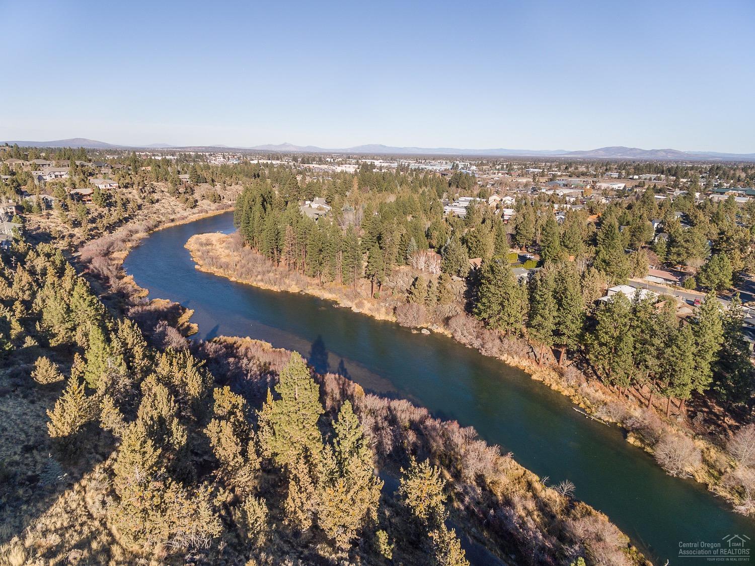 Perched above 1st St Rapids Trail, this gorgeous 3581 sq ft home is an oasis. Private .72 acre lot with nothing between you & the trail but nature. Walls of windows frame 180* views of Smith Rock, Pilot Butte fireworks, & Deschutes River. Elegantly causal, the 4 bedroom, 4.5 bath home boasts a showpiece American Clay fireplace, on trend farm-style kitchen, dramatic master, & on street private river trail access. Complete with oversize 4 car garage & ample toy storage. Home Warranty included with sale.