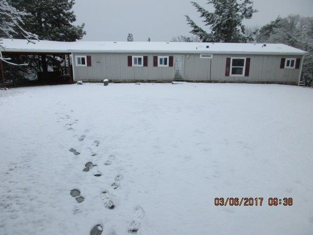 Nice peaceful location minutes from Jacksonville. This hillside property offers potential. Includes a two car detached garage and carport plus large deck area.