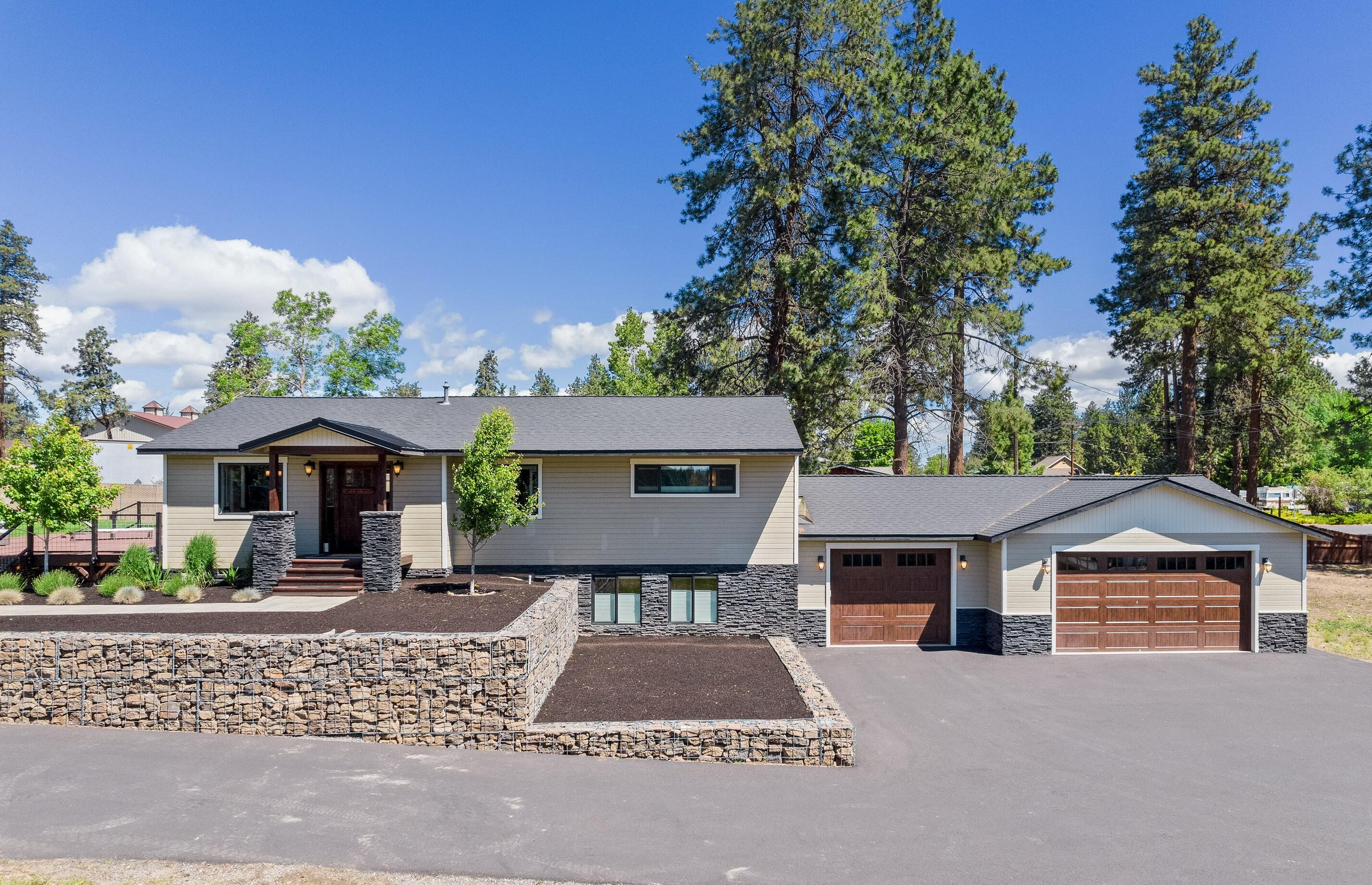 Outstanding home on 1 acre in town!! Fully remodeled and stylishly updated! The main level features an open floor plan with bamboo flooring throughout, tile surround fireplace, vaulted ceilings and lots of windows for natural light. The gorgeous kitchen features an oversized built in refrigerator, plus two beverage coolers, stainless appliances, quartz countertops, pantry, and breakfast bar. Master suite is on the main level and boasts a tiled shower, dual sinks, and his & her closets. Downstairs features guests rooms, a bonus room, full bath, and second utility room. Large back deck and new landscaping with a huge grassy area, plus a fire pit. Attached 3car garage AND a 1300+ sqft 2nd garage/shop with storage area. All of this on your own private acre! Just minutes from the highly anticipated Alpenglow Park (scheduled to be complete in 2022), downtown, and the Old Mill. Excellent southeast location with easy access to schools, shopping, and the parkway. Don't miss out!