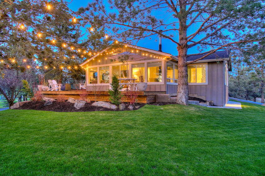 This darling boutique farmhouse sits on 1.74 acres, with 1 acre of COID irrigation, close to town and schools in the Bee Tree Subdivision.  Beautifully updated with solid surface counters in kitchen and bathrooms.  This home has 3 beds and 2 1/2 baths.  The primary bedroom has a full bath with a steam shower.  Bonus or sunroom with amazing natural light and a great family hangout area. Includes 1 wood burning fireplace in living area and 2 wood stoves, 1 in the dining room and 1 in the bonus room, which makes it one of the coziest you will find in Bend!  Lovely setting with outdoor deck and paver patio areas to enjoy the outdoor privacy.  Permitted tack room/studio and detached 3 car garage with Electric Car charger and tons of extra storage.  Beautiful newly fenced pasture for horses, goats, or other animals.  Across from Pine Nursery Park.  A truly unique property not to be missed! Homebook: https://issuu.com/firstamcs/docs/63210_overtree_rd_homebook?fr=sNzQ1MzU4MTkzMzU