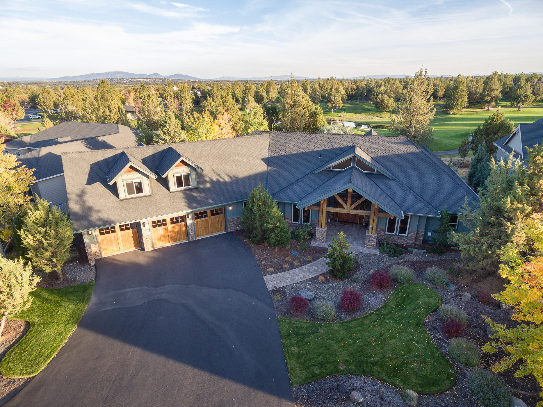 Upon entering this beautiful home, you will see not a detail was overlooked. The home features knotty alder trim and accents, knotty hickory kitchen cabinets, granite slab counter tops, 6 burner gas stove and room to host your family gatherings. Featuring a master suite, jr suite, two bedrooms/office and a 631sqft loft area easily converted into an additional bedroom with additional storage. For those that need storage. The home has an amazing 1,034sqft epoxy covered floor 3 car garage on an amazing .44ac lot on the 18th green of The Ridge Course at Eagle Crest Resort. Within walking distance of the clubhouse and the amenities provided by the resort. Grab your drink and sit on your heated back patio and spark up your outdoor fireplace while you watch the golfer wrap their round of 18 holes in your very own back yard.