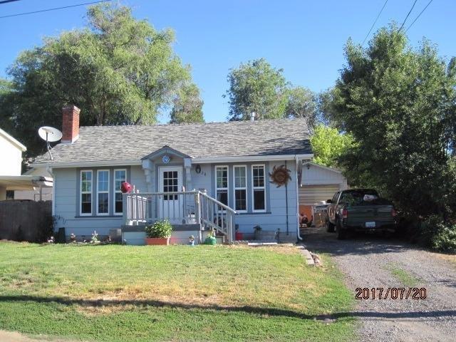 Remarks This is a cute little 2 bedroom, 1 bathroom home with separate living room open to the dining with a fireplace. Original hardwood floors throughout with vinyl in the kitchen, tile bath, and carpet in one bedroom. Large lot with a detached garage and deck in the back with low maintenance yard. The home has a newer roof on it with vinyl windows and gas forced air heat. The home could use some TLC but has great potential. Property being sold AS-IS!