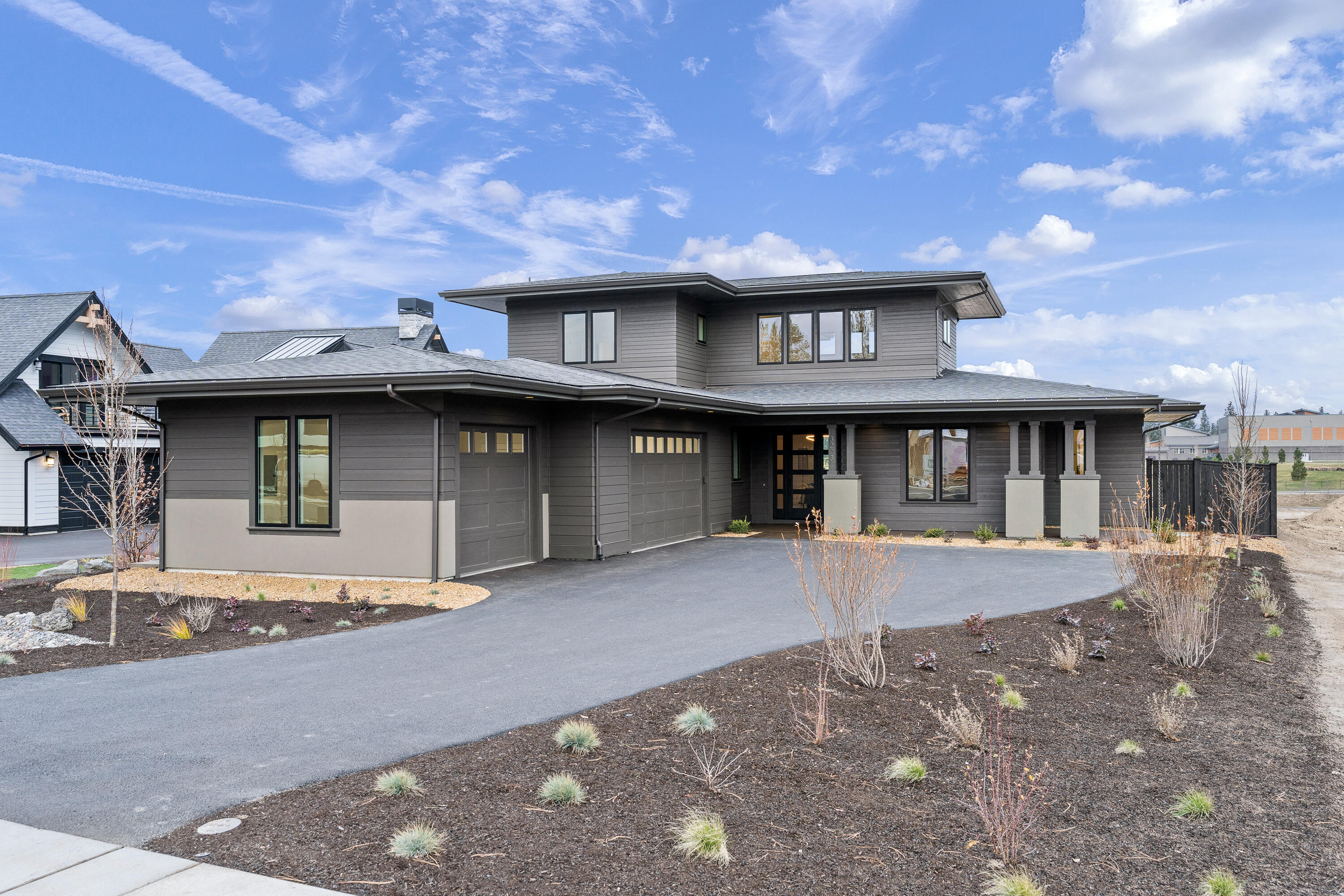 Gorgeous Prairie style home built by KD Construction. Located in sought after Discovery West on the west side of Bend, this contemporary home is perched on a bluff with expansive views of open space/greenbelt. Open floor plan with main level living featuring a primary suite, guest suite/ office. High ceilings, gorgeous hardwood floors and custom cabinetry built-ins flow to the spacious kitchen, complete with high end appliances, large island, and abundant storage. The generous Primary suite with luxurious bath features a freestanding soaking tub, walk in closet and full tile shower. Two guest bedrooms, full bathroom and bonus room are located on the upper level. Expansive back patio with plenty of space for year round outdoor entertaining. Triple-car garage and fully landscaped. Discovery West is thoughtfully designed to provide residents with pedestrian friendly streetscapes and conveniences like restaurants, shops, parks, schools and trails all nearby.