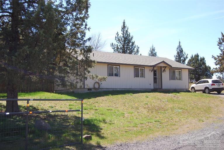 Ranch home with large storage building and large carport! Carport could be converted to garage. Good floor plan with vaulted ceilings, ceiling fans and kitchen island. Sliding glass door opens to covered paver patio. Property is spacious and completely fenced with a security gate at the driveway. Crooked River Ranch amenities include: golf, disk golf, tennis, pickle ball, horseback riding with lots of trails and spectacular fishing!