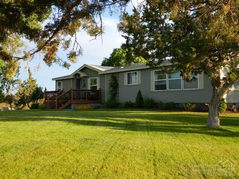 This home is on 6 acres and has beautiful views of the Three Sisters, Mt. Jefferson, and Smith Rock. Quiet neighborhood with easy access to Hwy 97, Hwy 126, and Redmond. Open and light floor plan with vaulted ceilings and upgraded flooring. Two decks plus patio. Park-like setting, horse pasture with shelter, and invisible dog fence.