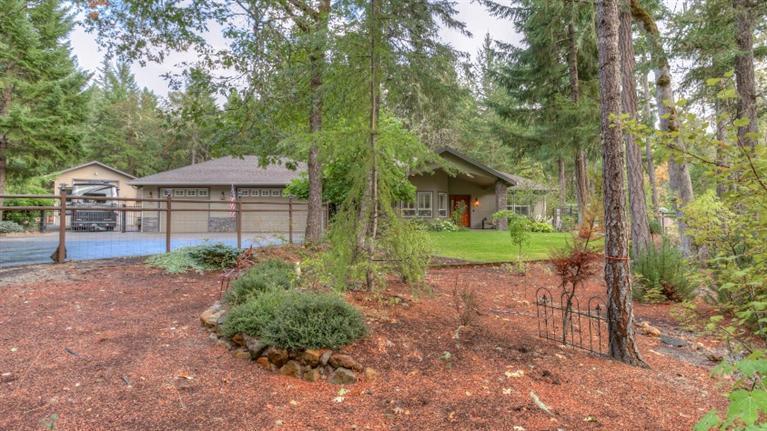 Absolutely stunning Chapman built home available now in the upscale Indian Ridge subdivision. Serenity among the trees can be found on this quiet cul-de-sac where you have your own park-like manicured 2.5 acres. 3 beds, 2.5 baths, open family area and split floor plan. Granite counters, custom lighting, fine cabinetry and high end appliances. Master bathroom features jetted tub, cultured marble and separate shower. Large 3 car attached garage, Extra Deep detached 46x20 RV garage and 16x30 media room and guest quarters with separate heatpump. 1 acre of manicured landscaping...the rest is wooded. Home Warranty Included.