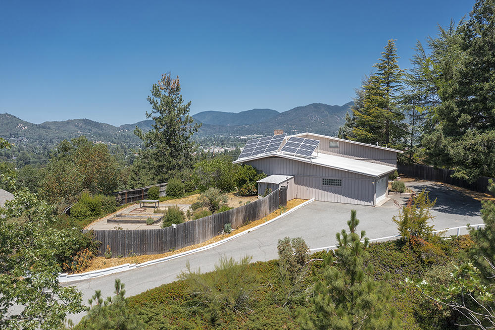 Fabulous 50's Flipper! Nearly 2900 s/f, 3 bedrooms, 3 full baths, incredible 'Hill Top' views over Grants Pass & surrounding mountains. True to the period w/ butler's pantry, banquet room, built-ins, gorgeous hardwood floors, real brick (likely the last of the locally fired/Hays Hill Brickyard!), glass block, brass (looking) knobs, tile countertops, solid wood cabinetry & all appliances, mudroom w/ w/d. Oversized finished/ins. 2 car garage w/storage & shelving & another large bonus room w/ built ins. 2 water heaters. Energy Efficient w/ Solar Panels to Lighten your Load. Durolast Roof. New heat pump. Electric insert in Fireplace. Natural gas available. Many dbl pane vinyl windows including large slider out to deck .77 of an acre zoned R-1-12. Room for ADU. Fenced yard, shed, concrete patios & pathways; owner filled in the inground pool not too long ago (!) Might be able to exhume & have operating again if Buyer desired. Gated & private. Evergreens & Established landscape. Appt Only.