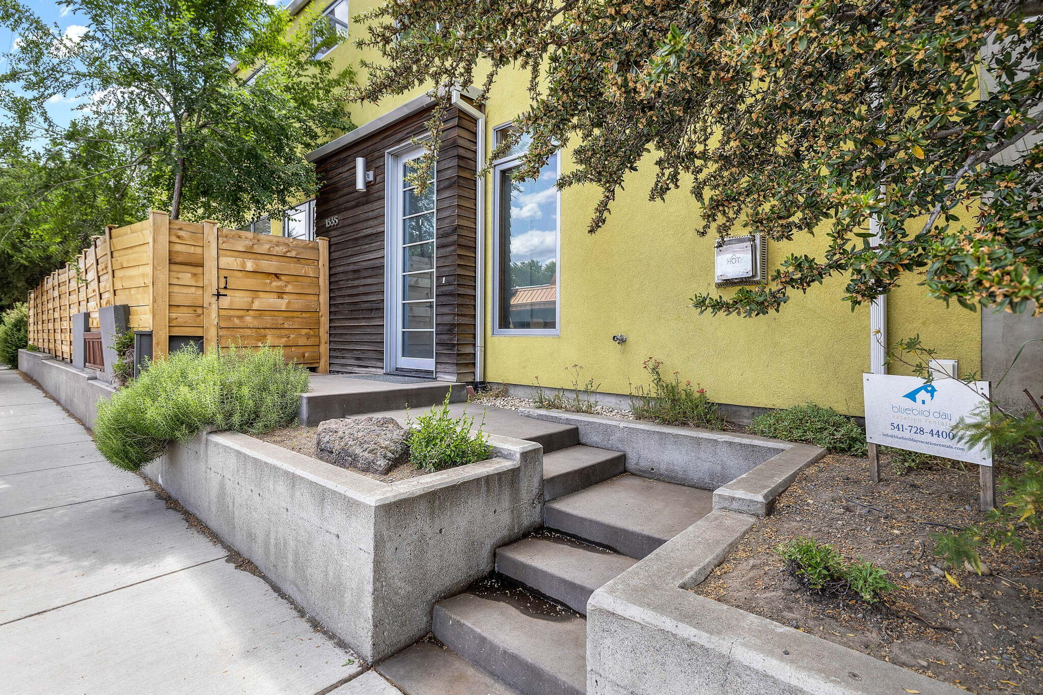 Eco-Friendly Modern Vacation Rental in the Heart of Bend's Vibrant Westside. Discover the perfect blend of sustainability, style, and location in this stunning LEED-certified vacation rental. Thoughtfully designed with a modern aesthetic, this 3 bedroom, 2.5 bath, 2145 sf home offers a warm, inviting atmosphere with radiant heated floors, solid wood doors, and a newly tiled fireplace anchoring the open concept living. The home features an organic fusion of reclaimed wood, metal, stone and glass creating a one-of-a-kind architectural experience. The spacious private primary suite includes its own balcony retreat, while the fully fenced patio and hot tub invite relaxing evenings outdoors. Walk to top-rated restaurants, coffee bars and Newport Market - just steps from your door. This property comes fully furnish with a rare legacy grandfathered vacation rental permit that transfers with ease to the new owners. Fully furnished turn-key investment opportunity! Oversized 1 car garage.