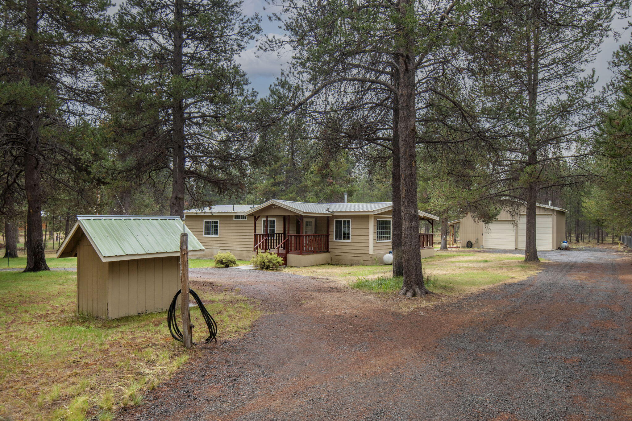 CALLING ALL VA BUYERS — THIS ONE'S FOR YOU!  Really nice floor plan in this 1248 sq.ft. home on 1.07 acre fenced/gated, w/circular driveway on culdesac. Whirlpool appliances, laminate wood floors, tile counters, vinyl windows, metal roof. Covered front & back decks, auto-sprinkler system. Forced air heat, A/C. 1080 sq.ft shop, heated, w/concrete floor, workbench, 2 roll up doors for RV storage. All kitchen appliances included.  You will love the 30 X 36 Shop with loft.  SELLER CONCESSIONS TO BUYER $10,000.
