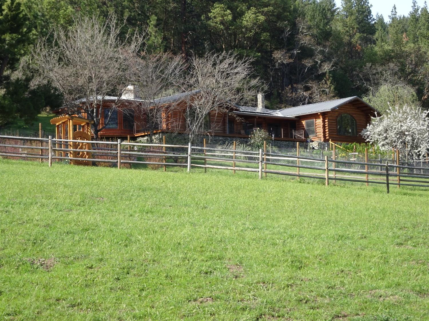 Spectacular private 241.57 ac ranch located on the E. edge of the Applegate Valley, only minutes to Jacksonville and Medford. Perfect mix of open & forested land w/ 4 tax lots for multi-family living. Property features a custom log home, completely remodeled, light & bright w/majestic valley & mtn views. Custom kitchen & bths has lots of artistic detail & woodwork throughout. Energy efficient improvements; locally made masonry wood stove(Kachelofen) creates a long-lasting radiant heat, a rock fireplace contains newer wood stove, 2 grid-tied solar systems & back-up generator. 800sq ft studio w/full bth & decks to take in views. 5 stall barn. Fenced & crossed fenced pasture, extensive trail system & access to public trails. Insulated shop. Water storage from spring, well & rain water catchment system into holding tanks. Pond can be used for irrigation. Established gardens & orchard.TL 204 & 200 have homesite approvals, TL400 has old gold mine & outbuildings. BLM on 2 sides.