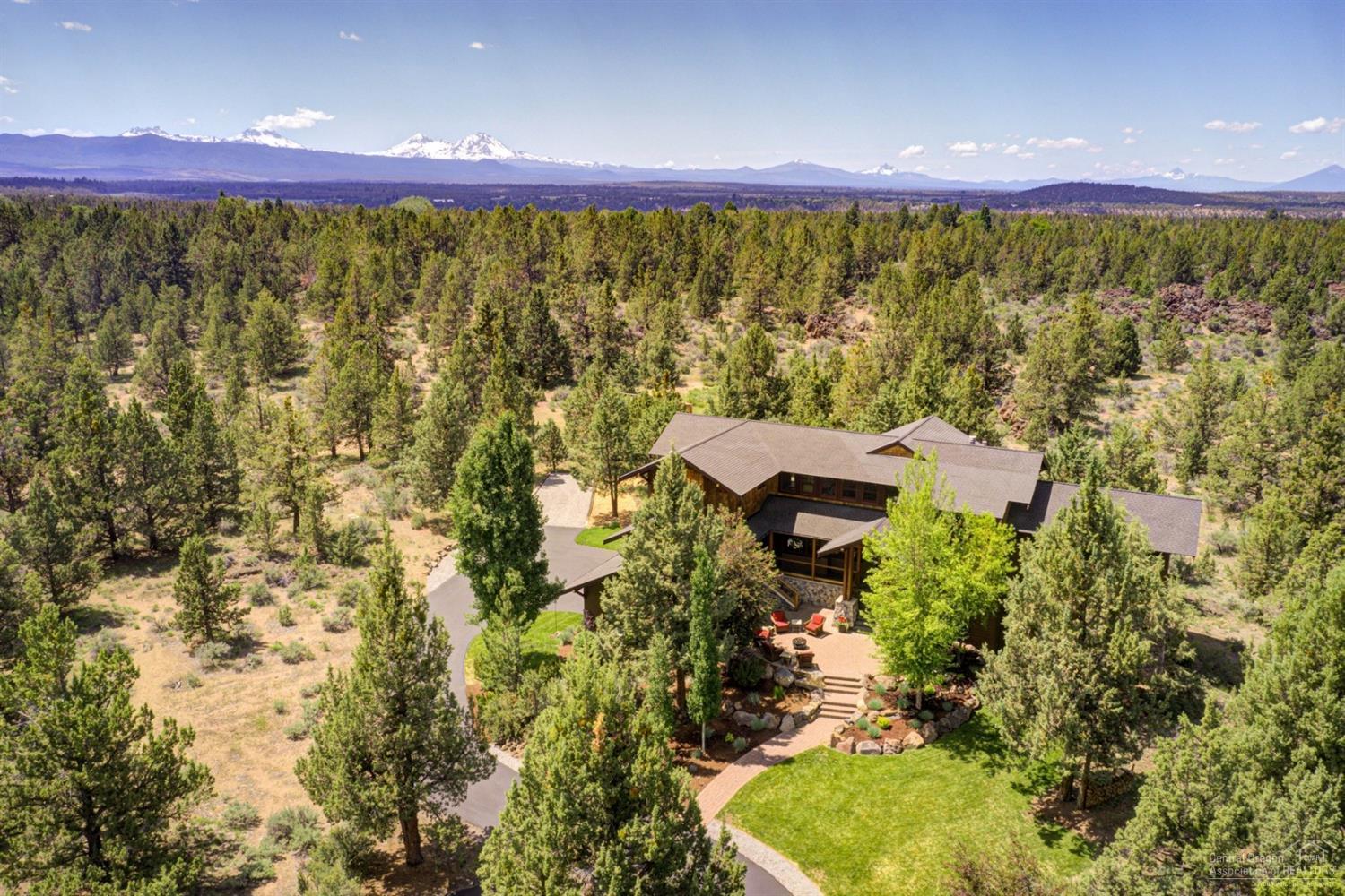 Minutes from downtown Bend, this breathtaking home was created by designer Jim Rozewski & custom builder Steve Bennett. Nestled on 4.5+ secluded acres near Tumalo this home offers privacy & natural landscapes. The exterior of the home offers a dramatic entry w/ multiple outdoor living areas. The interior offers a lodge style living room w/ a dramatic 20ft natural stone fire place, & floor to ceiling windows to enjoy a stunning view of Mt Jefferson. A chef's dream kitchen has a large island w/ 2nd sink, double oven & 6 burner stove, walk-in pantry & formal dining area. The master suite offers ample space, privacy & tranquility with peak-a-boo mtn views, private deck & sitting area with a fire place. 2nd living room, loft space, work out room, extensive storage spaces, large mud room, an oversized 3 car garage. The property features a high fenced garden with water, recreation area with artificial rock climbing boulders, full-length RV pad.