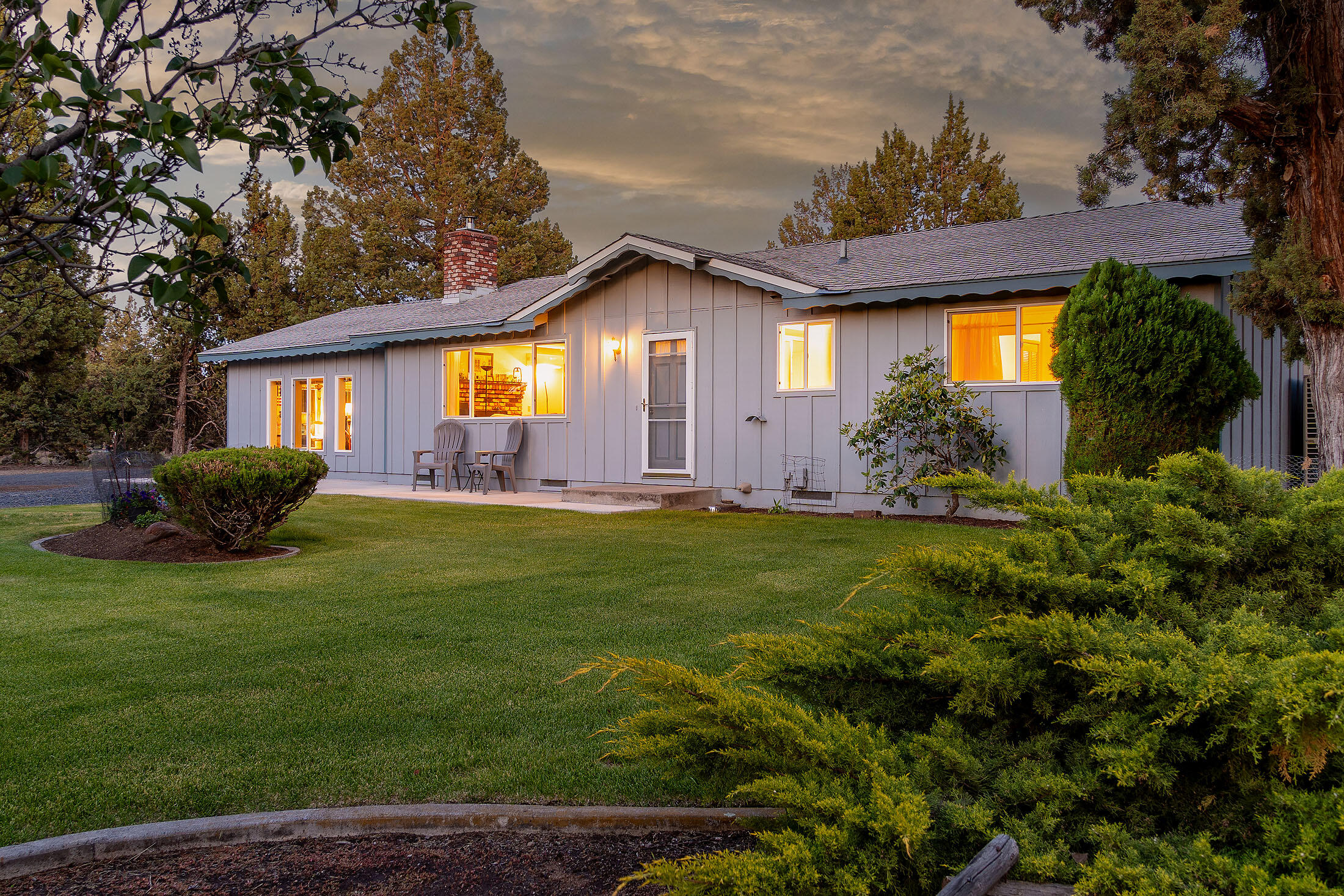 Comfortable living offered in this well-constructed & updated 4 bed, 2 bath, 1,272 sq ft home built in 1973 on 2.5 acres just NW of Bend. Exceptional privacy in this peaceful rural setting situated among mature trees & lush landscaping with underground sprinklers, drip system, & fruit trees. The living room features a wood stove insert with brick hearth, mini-split for efficient heating & year-round comfort. Extended outdoor living on the covered back patio allows you to enjoy the thoughtfully designed landscaping that creates a peaceful retreat. Fenced and gated property with large garden area and natural space for ample parking. Heated garage/shop with built-in workbenches, & additional carport offers room for projects, storage and parking easily accessed by circular drive.