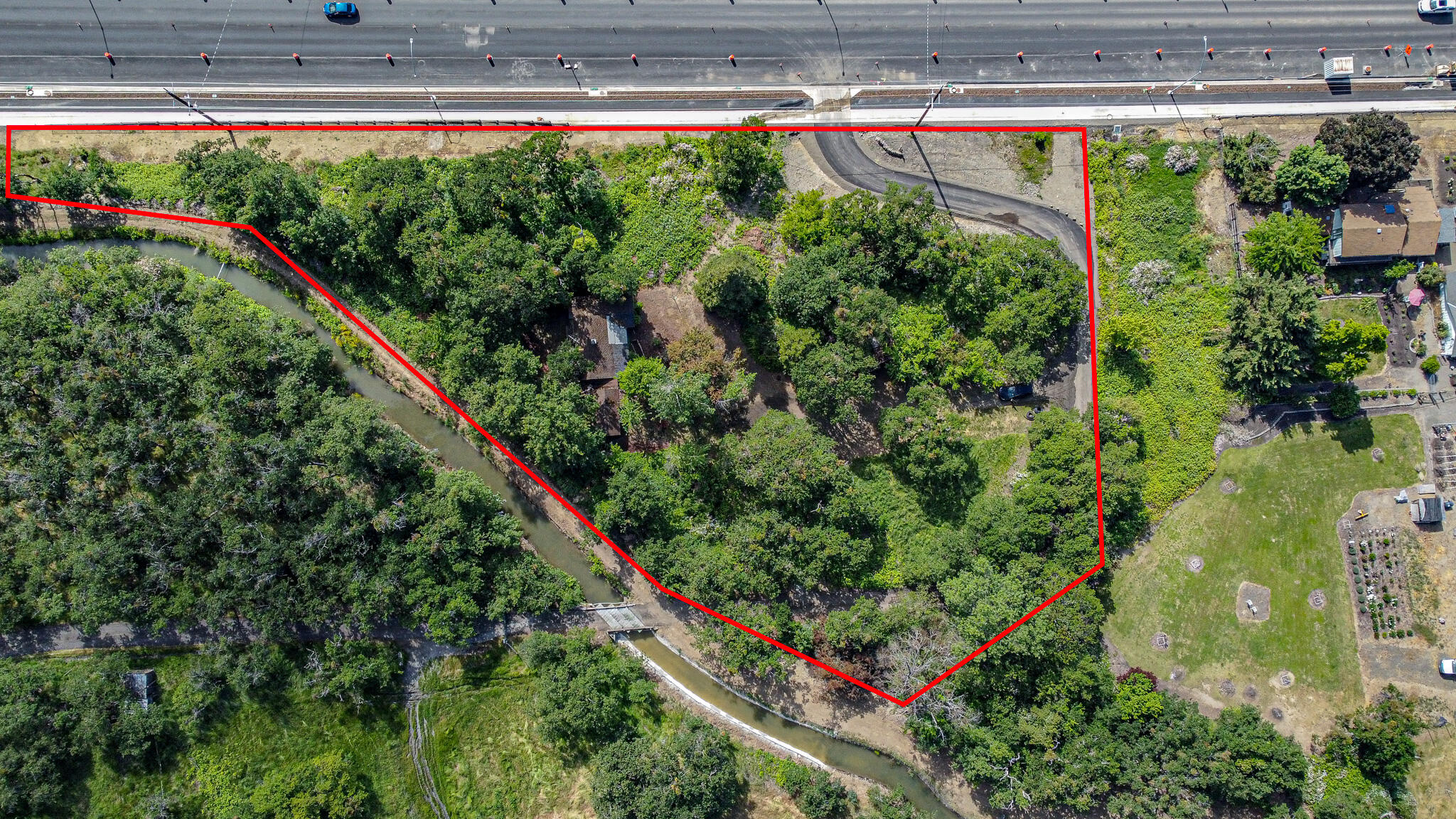 North Foothill now improved along this view building site, with sidewalk, bike lane, retaining wall, and new driveway!  With views of the West Hills and Table Rocks, this property offers the benefits of a rural lifestyle while still having the convenience and reliability of some city services! Build your dream home on this private and treed building lot inside East Medford's Urban Reserve, surrounded by upscale homes, and just minutes from shopping and parks. Mature trees, some landscaping and fruit trees. Existing dwelling is currently not habitable or safe, is boarded up, and has little to no value but is left in place to hold building site. New water meter.