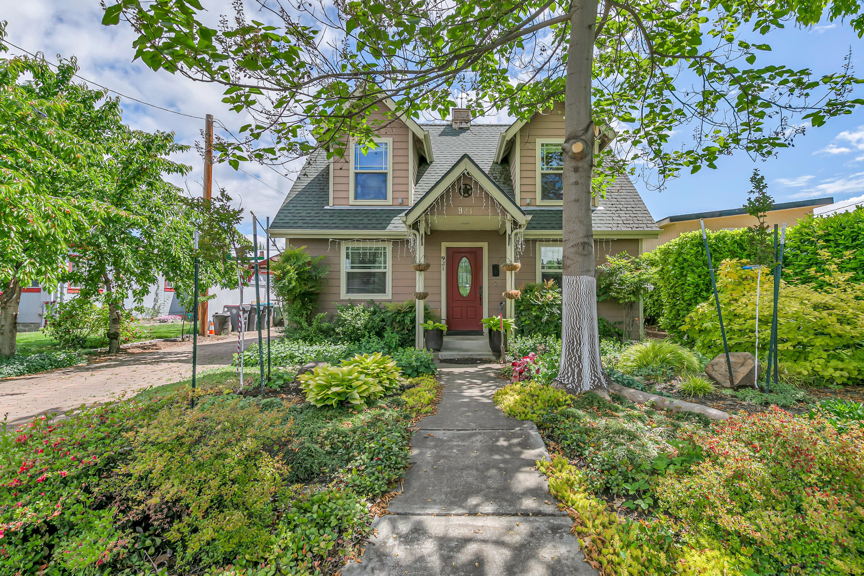 Opportunities abound with this cute Cape Cod home in southwest Medford. With the detached one bedroom, one bathroom ADU, garage with workshop and sauna, this is the perfect property for multi family, investor, or hobby enthusiast. The main home features 8ft ceilings on the first floor and 12ft vaulted ceilings upstairs. The updated kitchen has beautiful hickory cabinets, complementary granite counter tops, pull outs, and soft close hinges. The primary suite is on the main level, while the two additional bedrooms with picturesque window seats are upstairs, which creates a great separation of space. The front yard was designed by a landscape architect which is shown by the cobblestone drive, 5 fruit bearing cherry trees, and other mature flora. The backyard is fully fenced with an 18'x24' raised garden bed and covered back porch. The outdoor shower is perfect for rinsing off before or after getting in the hot tub. With its charm and convenient location this is a hard home to beat!