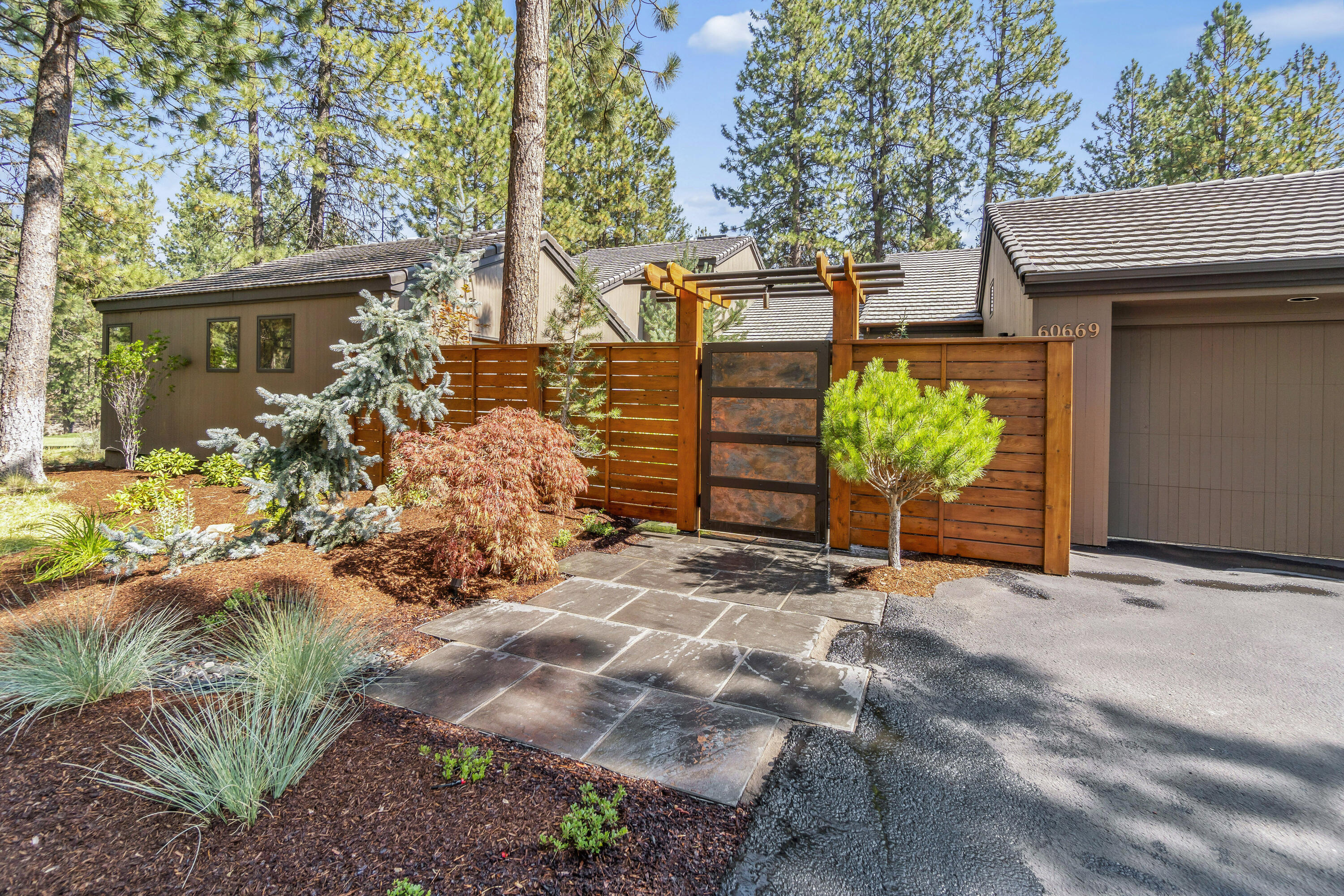 One of a kind light-filled NW Contemporary home, built on the premier lot by the founders of Widgi Creek, lies along the Deschutes River side of the development overlooking a pond. Extensive remodeled interior in 2018 includes new paint, 3 contemporary bathrooms with heated floors, refinished hardwood floors, wool carpeting, and epoxy garage floor. Inside the home are 2 offices, several window seats overlooking the pond, family room, and living room with wood burning fireplace. 2019 exterior landscaping features a beautiful copper entry gate with heated tile for snow, leading to a private courtyard with Trex decking, water fountain and night lighting. Outside the courtyard, woodland xeriscaping with drip irrigation, large deck along the river side and grounds night lighting. The home opens to hiking trails along the Deschutes River, mountain biking access to the Bend Trail system, paved bike path to Bend, and only 15 minutes to Mt. Bachelor and the Cascade Lakes.
