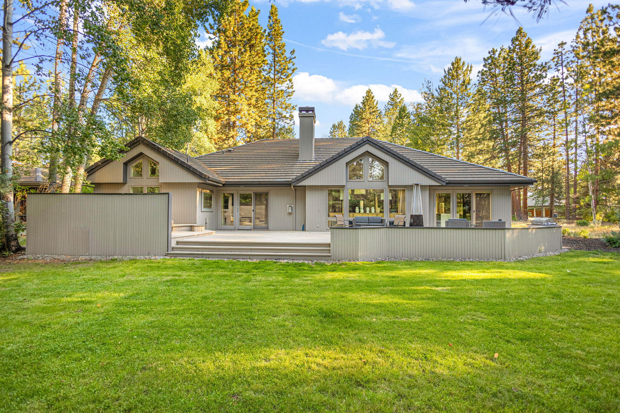 Discover this beautifully remodeled single-level gem in Bend's sought-after Broken Top neighborhood. Offering 4 bedrooms (or 3 plus a home office), including a guest suite with its own ensuite bath. The great room is sure to impress with it's vaulted ceilings and a striking herringbone-tiled gas fireplace setting the tone for cozy evenings or lively gatherings.  The kitchen features two  islands that invite you to gather, graze, and celebrate in style. The luxurious primary suite features a gas fireplace and private access to the lush backyard oasis. Slip into the hot tub just steps from your bed and soak under the stars. For the adventurers at heart, the oversized tandem 3-car garage is the cherry on top — offering built-in cabinets, a workbench, and plenty of room for all your Central Oregon lifestyle toys. From bikes and kayaks to skis and paddleboards, there's space for it all.
