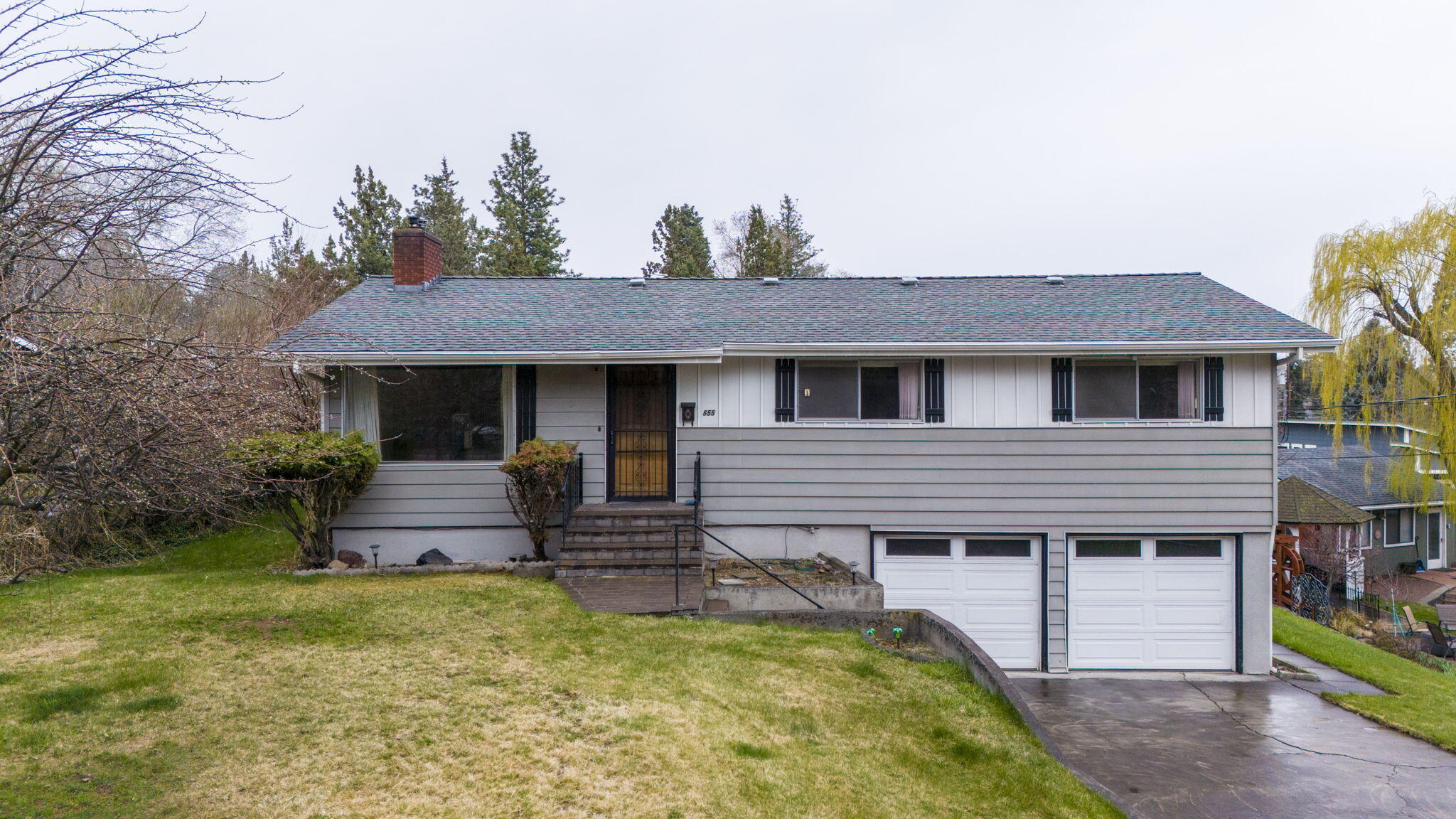 Classic mid-century home located in NE Bend's Orchard District on 0.24 acres w/development opportunities for the savvy buyer. This prime location is min from Hwy 97 access, Pilot Butte, Orchard Park, & all Downtown Bend has to offer!  4 beds, 2 baths & 1536 sf of living space w/rear alley access. Main living area is open & bright w/a cozy stone fireplace, carpet that has hardwood underneath plus there is an additional family room downstairs! Kitchen ftrs plenty of storage & counter space for prep, vintage appliances & open dining area w/sliding glass doors. 3 bedrooms on main level  w/full bath & another bedroom downstairs w/full bath. Potential income opportunity when considering turning downstairs family room, bed/bath into a separate dwelling space. Huge yard w/plenty of room for outdoor activities & entertaining. Covered Deck off the dining area, double car garage, & RV spot out back. Potential to add additional accessory dwellings or lot subdivisions. Bring your imagination!