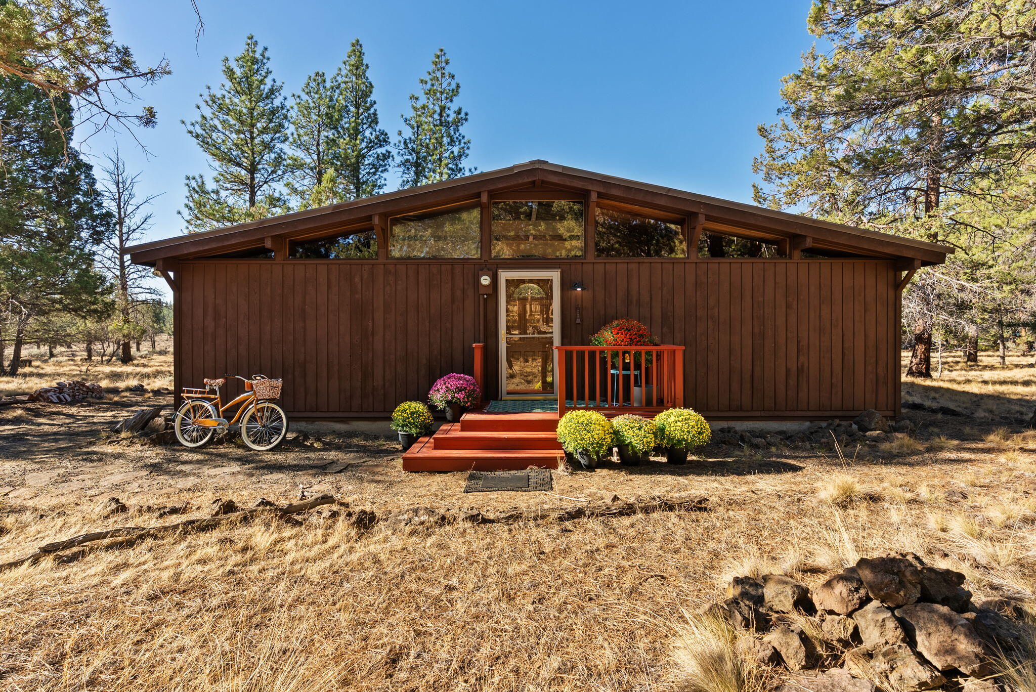 Step back in time and discover this original 1966 cabin. 950 SF, great room, kitchen, laundry, loft, 2 bedrooms, and 1 bath. Nestled on 1.75 private acres within the highly desirable Indian Ford Ranch area on ''The Hill'' in Sisters, Oregon. This property offers a lifestyle of tranquility and connection to the past, making it a unique retreat for those who appreciate true craftsmanship and character. The heart of the cabin is the vaulted, beamed great room, anchored by a warm propane fireplace, creating an inviting atmosphere for relaxation. The functional kitchen features charming vintage appliances, and the home is completed by 2 bedrooms, 1 full bath, a loft, and a dedicated laundry area with an included washer and dryer. A large back deck extends your living space into the private, natural surroundings. This enchanting red cedar, post-and-beam A-frame is located approximately 2 miles from downtown Sisters, where you'll find shopping, schools, and more!