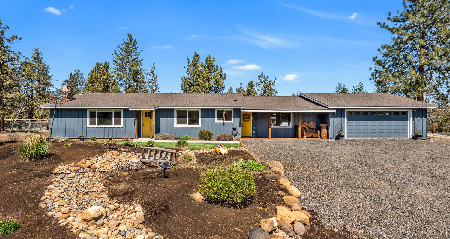 Updated single-level home in the Sisters area on over 2.3 fenced acres. The open floor plan showcases a living room with a vaulted exposed beam and wood inlay ceiling, natural rock surround wood-burning fireplace, and a refinished kitchen with quartz counters, updated cabinetry, and stainless steel appliances. A bonus rec room offers more room to entertain with a slider to the private, cross-fenced backyard, generous patio and updated landscaping with cost savings from a well fed sprinkler system. The property includes a detached insulated office with power and high-speed internet, a greenhouse, a refinished garage with extra storage and workshop space, whole house cooling with heat pump, and perimeter fencing with a ranch entry gate and horse stable with power. Pride of ownership is evident in the numerous property improvements, including new exterior and interior paint, carpet, window shades, wiring and lighting updates, power for RV hookup, and meticulous grounds maintenance.