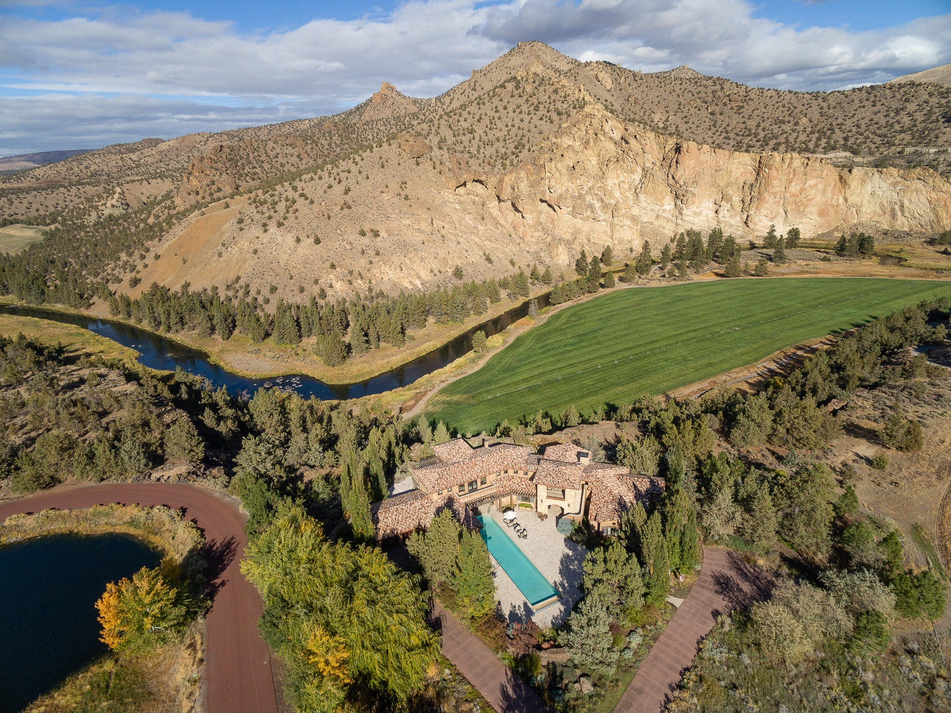 This spectacular Ranch at the Canyons property provides the serenity, privacy and ambiance you've been looking for. This Norman Building and Design masterpiece features an impressive great room with stone fireplace, travertine floors, mahogany beams, and overall casual elegance. Your lifestyle will include the Olympic sized lap pool, chef's kitchen with quartzite counters, gorgeous master suite, media - game rooms and a wine room. An elevator leads to the second floor guest suites and office with stunning views of  the bend in the Crooked River, the vibrancy of Smith Rock's Red Rock Canyon, hundreds of acres of hay fields and wildlife passing by. Enjoy indoor-outdoor living on the extensive patio with built-in BBQ, fireplace, covered dining and hot tub overlooking the canyon.  Ranch amenities include the Clubhouse w/ pool, fitness, guest suites,, tennis; equestrian center; outdoor event venue; stocked ponds; & 8 miles of trails within the 1700 acres of paradise
