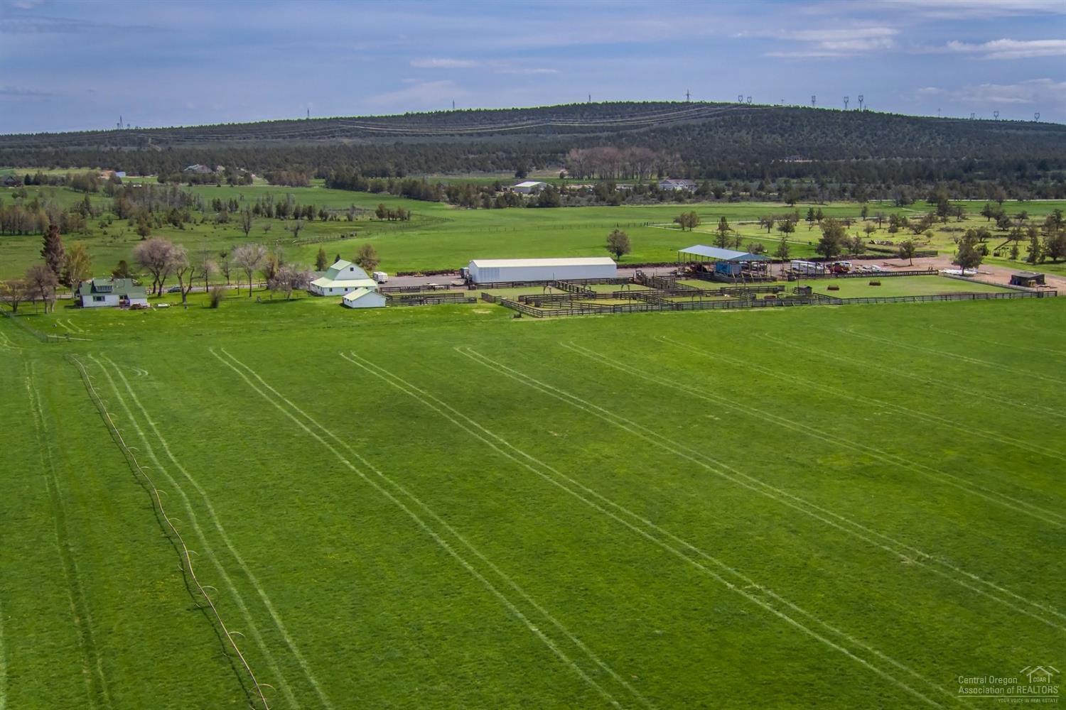 Central Oregon Ranch in the heart of Powell Butte with Cascade Mountain, Smith Rock and Little Houston Lake Views. Ranch is 498 acres with varied topography and 309 acres of COI irrigation water rights irrigated with flood, gated pipe and wheel lines. Little Houston Lake abounds with birds, wildlife and fish for recreational opportunities. Original Ranch Home is 2030 sf 4 bedrooms, 1.5 bathrooms. Additional Dwellings: 1279 sf home 3 bd, 1 bath. 1006 sf 2 bd, 2 bath with 240 sf detached garage. Outbuildings: 3600 sf Machine shed, 4000 sf hay barn, 1300 sf barn, 720 sf agricultural building, 920 sf building. The ranch is perfect for livestock, hay, recreation and has several wonderful building sites. Please be respectful and do not drive down driveway, property is shown by appointment only.