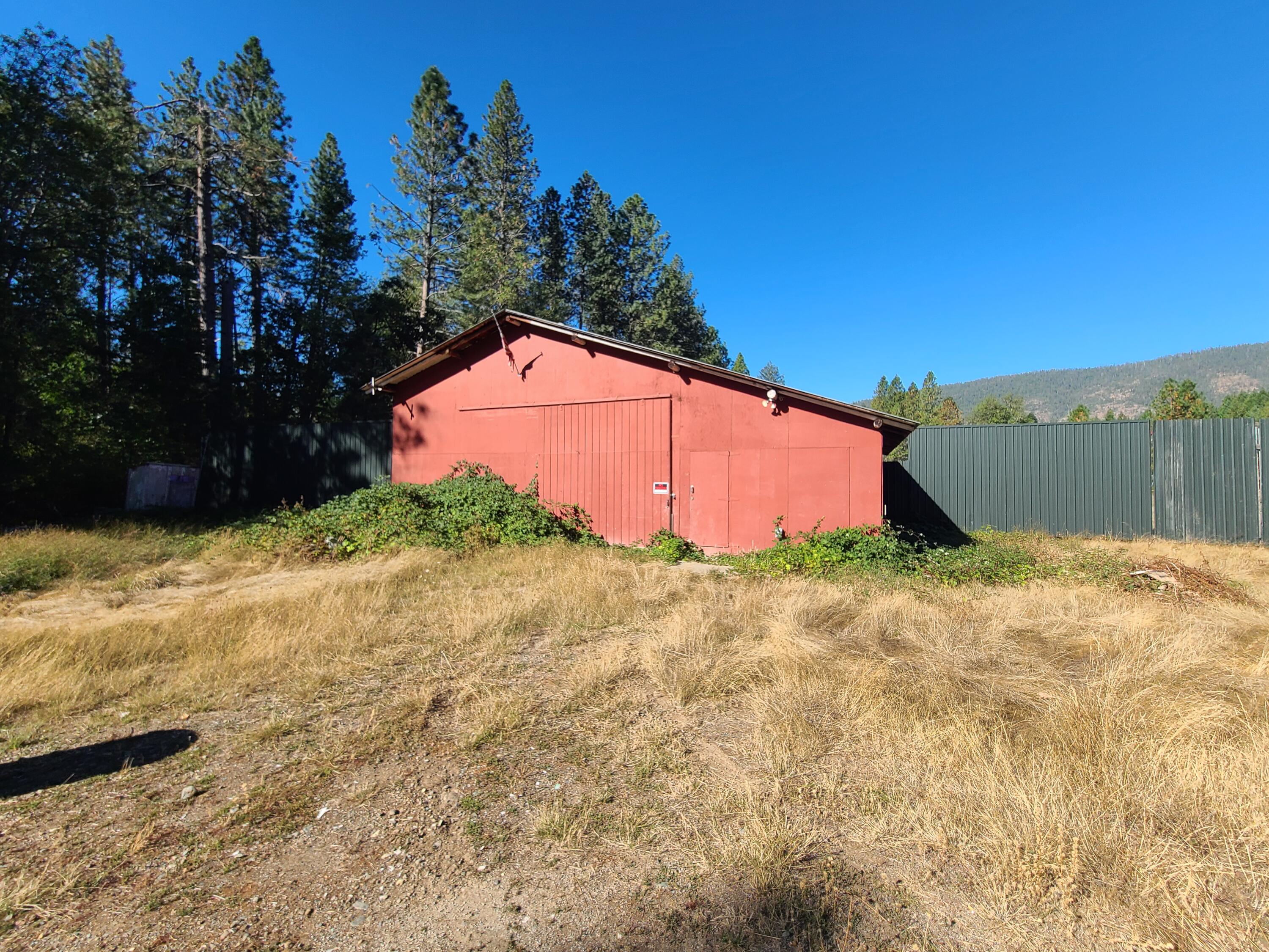 Beautiful Mostly Flat 5 Acre Property With Additional 1.53 Acre Separate Tax Lot & Seasonal Stream! There Is Large Shop Built With Round Wood Timber & Electrical For RV Hook Up! Home Is Uninhabitable & The Value Is In The Land & Oversized Shop!! Owner May Carry With 100K Down Short Term. Well & Power To The Property. Previous Well Flow Report On File From 2024 Averaging Approximately 5 Gallons Per Minute. All Information Is Deemed Reliable, But Not Guaranteed! Buyer's due Diligence!