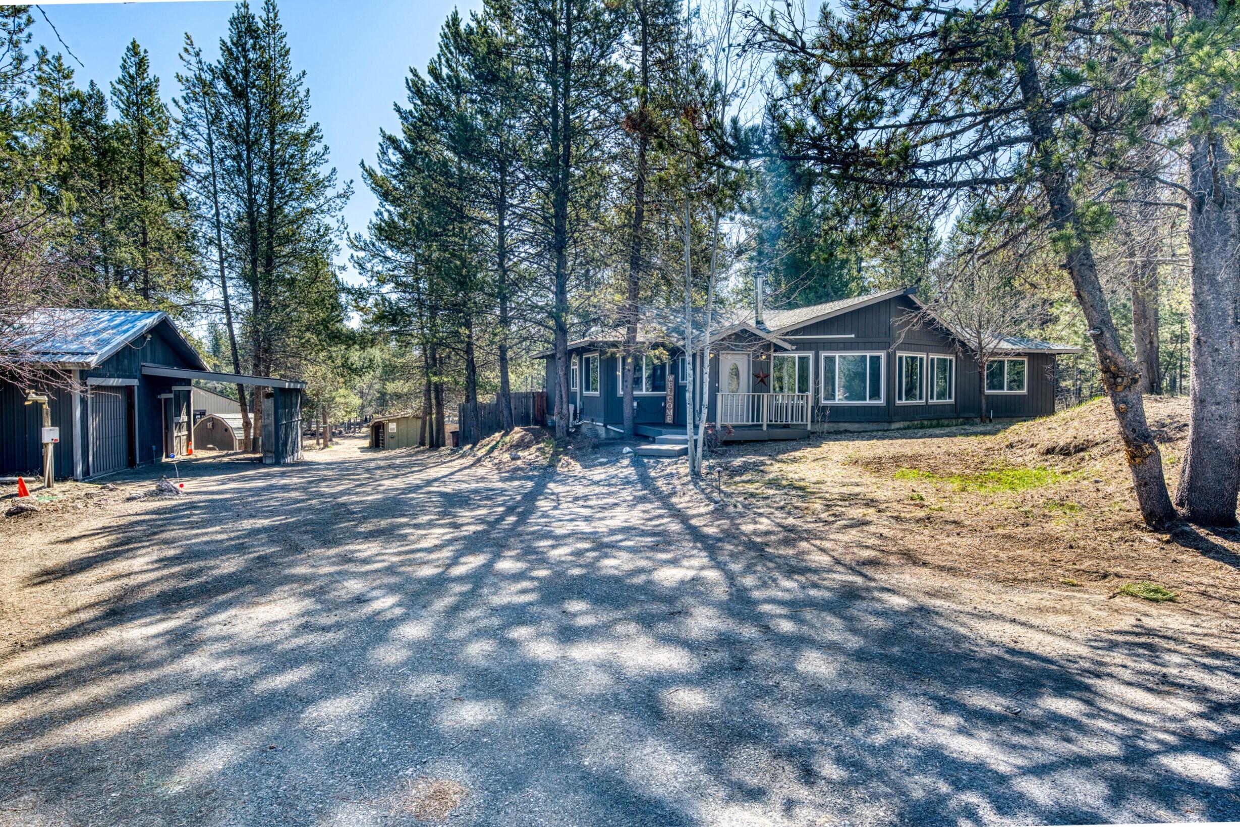 Seller to contribute $10,000 towards buyers closing costs, pre-paid items and or rate buy down. Charming Frame Built home on 3.5 acres with several outbuildings in desirable Lazy River South area. Located on a paved street in a quiet neighborhood. Short distance to Quail Run Golf Course and the Little Deschutes River. Recent updates include new windows, carpet and interior paint. 1,680 sq ft of inviting living space with 2 bedrooms plus a versatile den that can easily transform into a third bedroom. Open kitchen with ample counter space and seamlessly connects to the expansive living room with French doors. Large windows flood the space with natural light, complemented by the vaulted ceilings that create an airy atmosphere. Home features a primary bedroom w/generously sized ensuite bath. You will appreciate the 40 x 80 multi-use building for animals, toys, rigs, or equipment! Includes a detached one-car garage with a rustic workshop, along with various outbuildings!