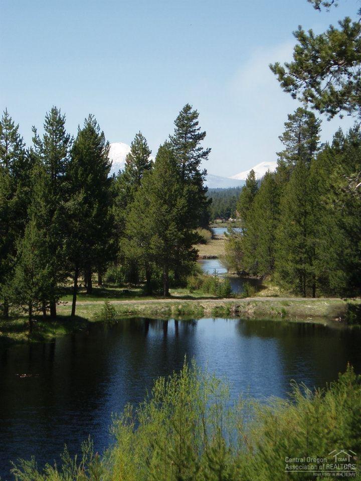 Extremely rare 70+ acres of seclusion on the Big Deschutes River w/ private harbor access to river. Lodge style w/expansive 40x40 great room overlooking river, harbor, private 3 acre lake, Cascade Mt. views. Just 20 min. to Bend. A +/-3000 sq. ft. remodel in the 90's. Main level living w/2 master suites. bonus rooms in daylight basement, gourmet kitchen, 3 car garage w/room above. Park like setting. Tax deferral on 65 acres at just $60 per yr. 2-M49 res. lots app. on property. Deer,elk,ospreys & privacy.