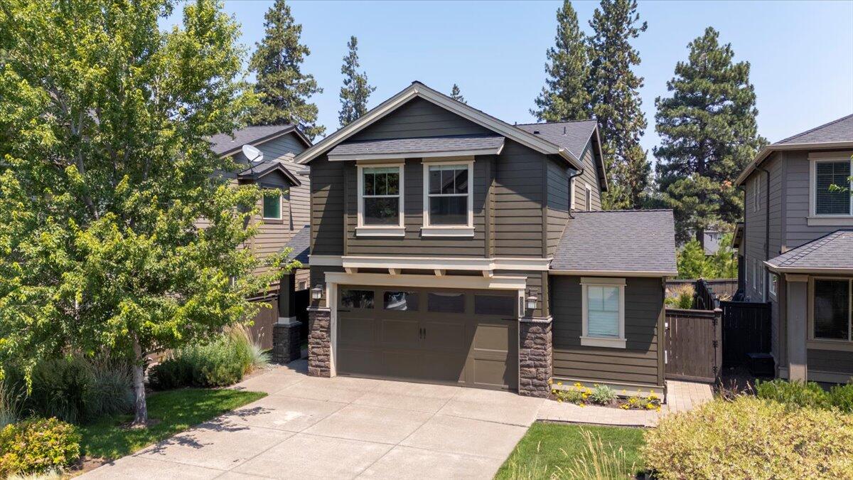 Location! Location! Come to Stonegate, a Pahlisch Home Development in SE Bend. Open floor plan with stone gas fireplace, Gourmet kitchen with Quartz countertops, center island &  SS appliances. Large back covered patio overlooking beautiful backyard flower garden. Back gate leads to common area and trails. Master suite is separate from other 3 bedrooms with coffered ceilings & large walkthrough closet. There is an additional side space in garage for a workshop area. HOA amenities include: pool, clubhouse, hot tub, trails, front yard landscaping, snow removal & playground. Easy access to Bend Parkway heading North through town. Less than 5 minutes away from Lost Tracks & Old Back Nine Golf Courses.