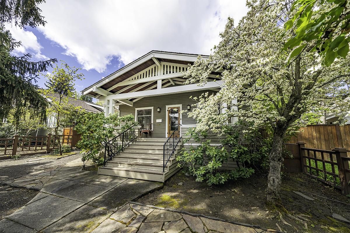 Sold Only. Cowslip's Belle Vacation Rentals include six furnished units in the Siskiyou-Hargadine Historic District, just three blocks from dining and entertainment of  Ashland's downtown plaza! The Turner House was built in 1913 by carpenters Borrow and Leonard and 'likely designed by architects Bowen and Smith, known for Ashland's best articulated bungalow designs' per National Register of Historic Places. Currently configured as two units with four exterior entrances, Turner House features a broad covered front porch with stately posts and exposed beams, original woodwork, period fixtures and hardware, beautiful leaded glass cabinetry, formal living and dining areas, two fireplaces, full gourmet kitchen, along with a separate kitchenette. The back Carriage House has four units ranging from ~270 to 600 SqFt; two suites with full kitchens and gas fireplaces. Multiple decks overlook a tranquil garden with mature trees, plantings, grass lawn, and koi pond.
