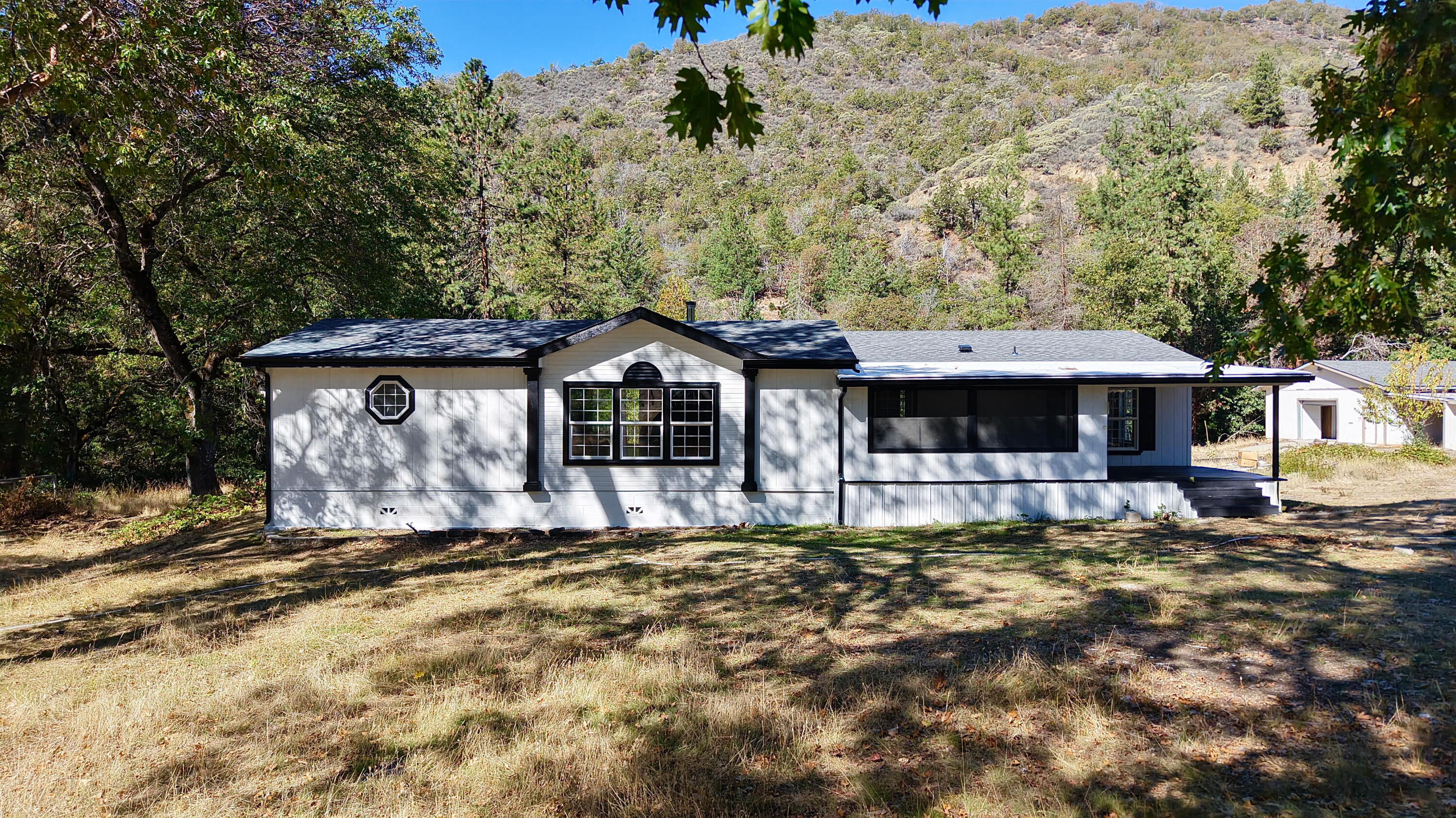 This home is now MOVE IN ready!! 

The spacious 2,300 sq. ft. triple-wide manufactured home has been extensively updated -with over $70,000 in improvements for its new owner to enjoy.

Major upgrades include:

-Brand new roof, HVAC system, siding, gutters, and downspouts
-Fresh exterior paint
-Restored and reinforced back deck
-CMU blocking repaired and skirting secured
-New tie-downs installed to current Oregon code
-New stove and dishwasher
The interior was also tastefully updated in 2019, offering modern comfort and style throughout.

Outside, you'll find a HUGE shop with a brand-new roof and additional repairs completed, irrigated garden beds, and a peaceful creek running along the back of the property. With 26+ acres to explore and enjoy, there's room for recreation, privacy, or even small-scale agricultural use. Both well and septic inspections are completeâ€”and the well produces an impressive 27 GPM
