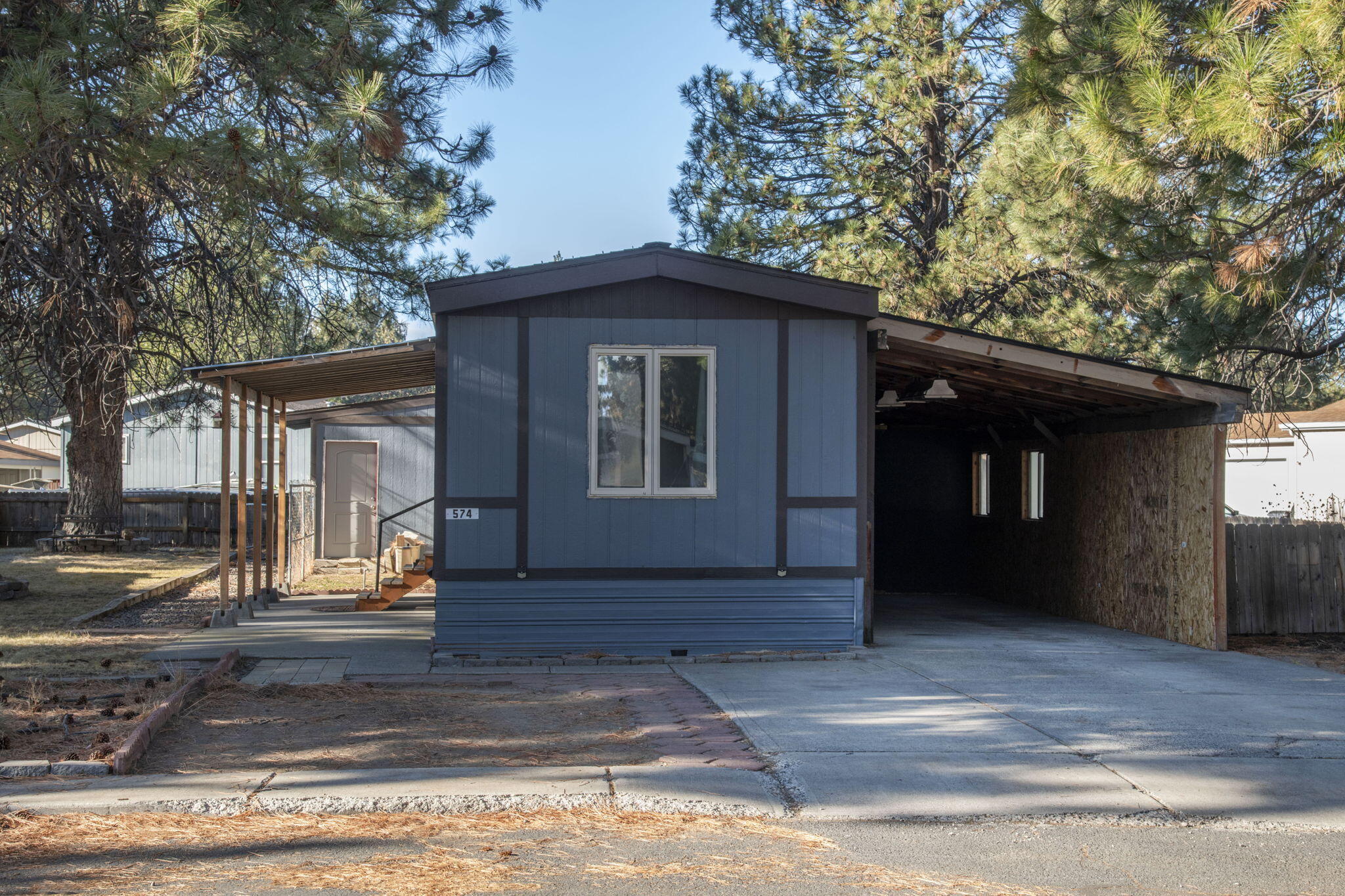 Located on a hard-to-find double lot with a grass area, private deck, and fenced space. Plenty of parking and outside storage. Inside, you'll find 3 bedrooms and two full baths, a kitchen island with storage, and a laundry nook. Space rent includes snow removal, clubhouse access, play court area, & maintenance of common areas. All occupants must undergo park approval, which includes a background & credit check. Sold AS-IS. This home is in a Park on leased land. Mobile Only for sale.