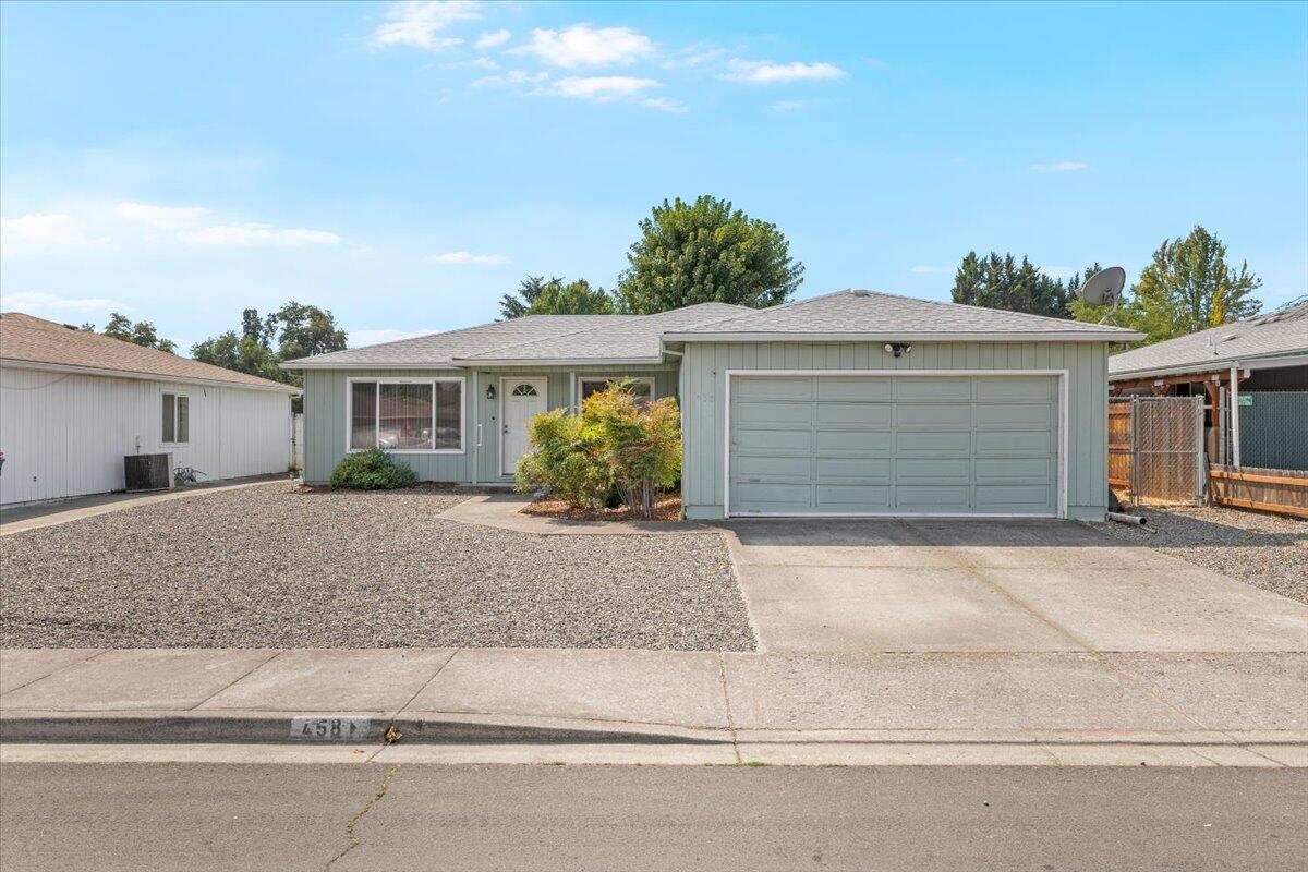 Don't miss this move in ready single level 3 bed 2 bath home. Outside you are greeted by fresh, low maintenance landscaping, including new rocks and weed liner, as well as a large driveway for ample parking. Inside you are welcomed by an abundance of natural light and new flooring throughout. The smart floorplan hosts an open kitchen and dining area complete with sliding doors to the covered patio and fully fenced backyard, as well as a spacious living room, full bathroom, two generously sized bedrooms, and a primary with full ensuite. A dedicated laundry room flows seamlessly to the attached 2 car garage. With recent updates like newer AC, newer stove, newer toilets, this home has it all; come take a look today!